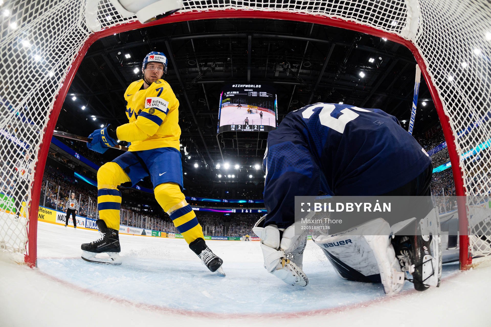 Henrik Tömmernes of Sweden against goaltender Harri