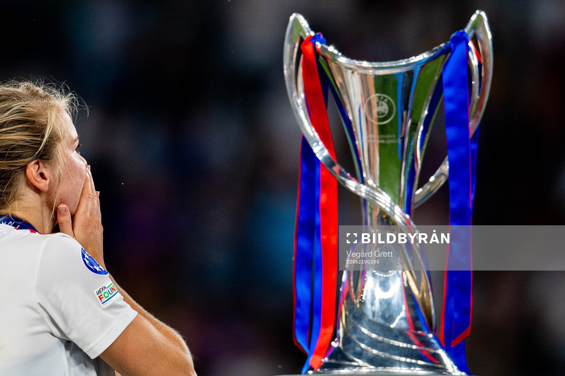 Ada Hegerberg of Lyon walks past the winners trophy