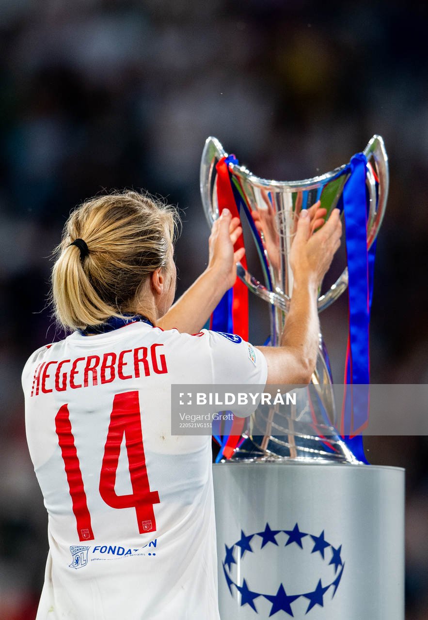 Ada Hegerberg of Lyon walks past the winners trophy