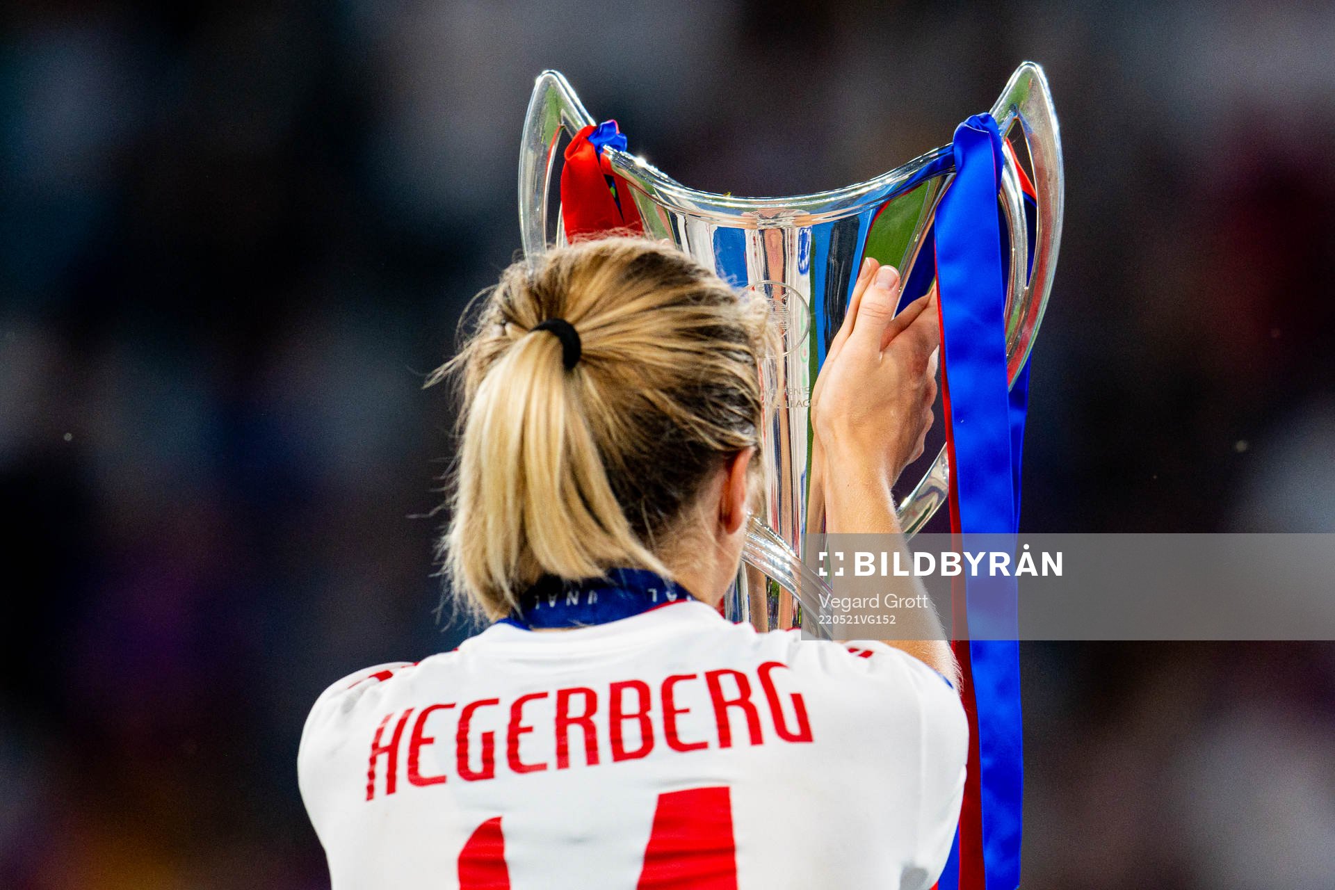 Ada Hegerberg of Lyon walks past the winners trophy