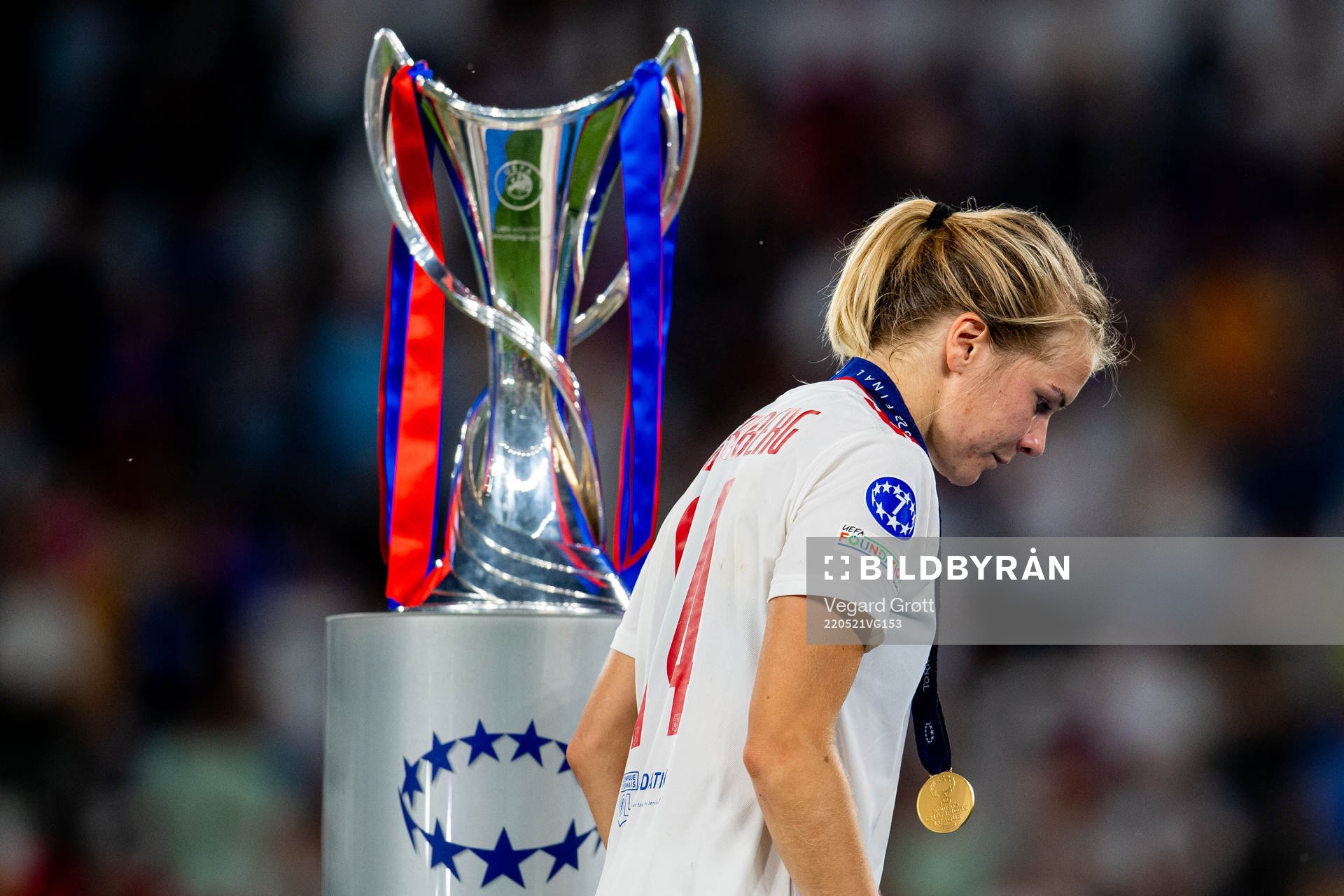 Ada Hegerberg of Lyon walks past the winners trophy
