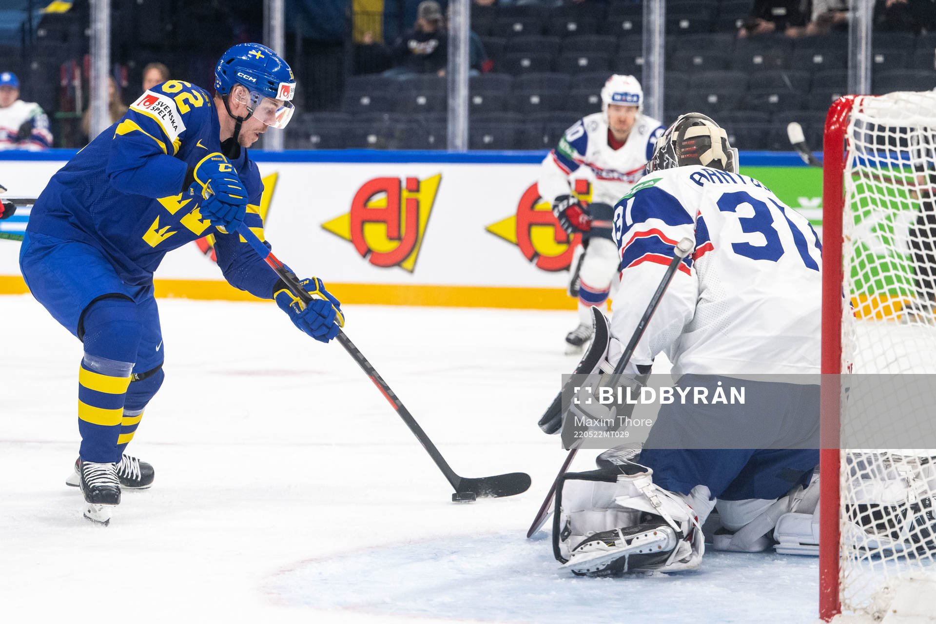 Joel Kellman of Sweden and goaltender Jonas Arntzen of