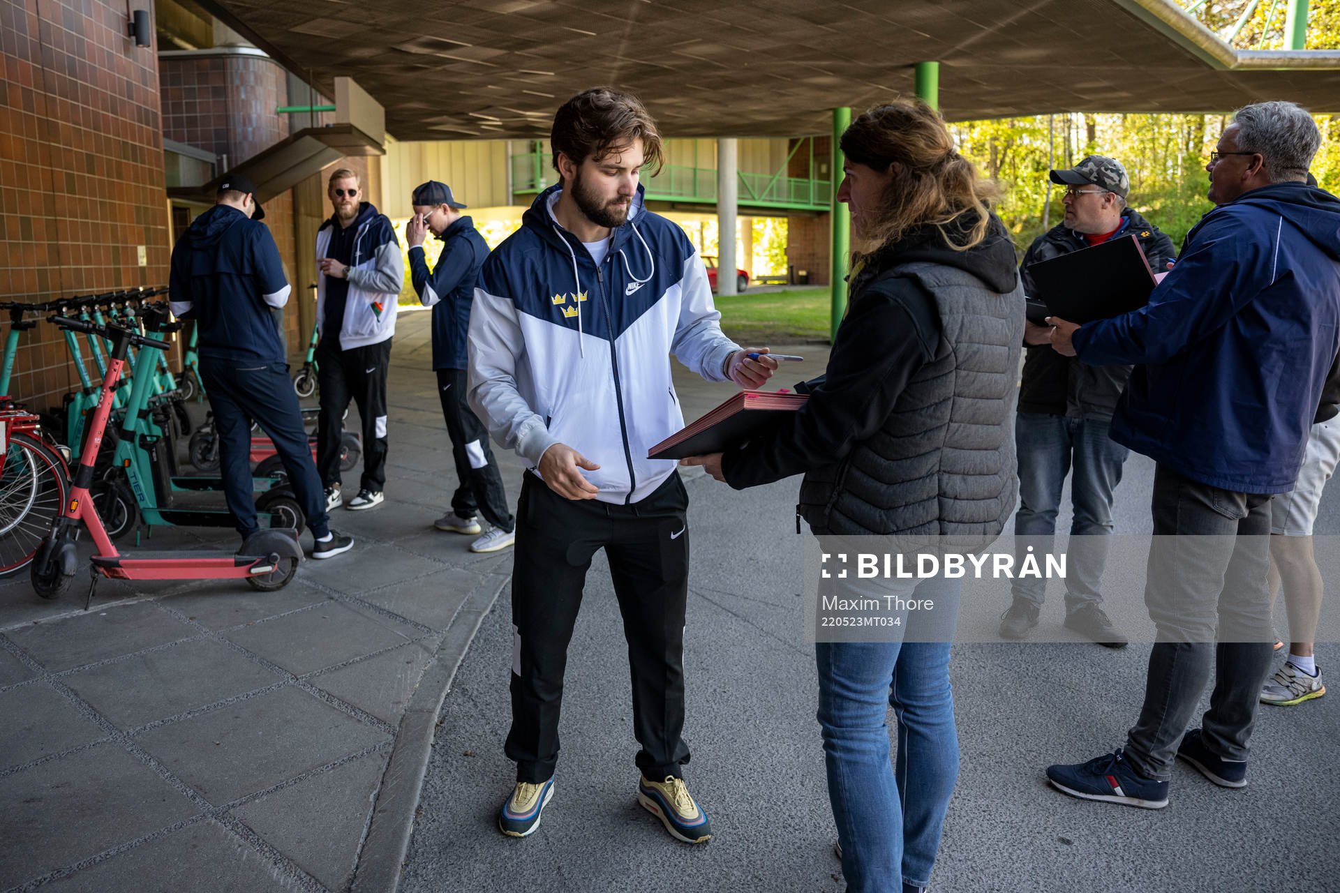 Emil Bemström of Sweden write autographs outside the hotel