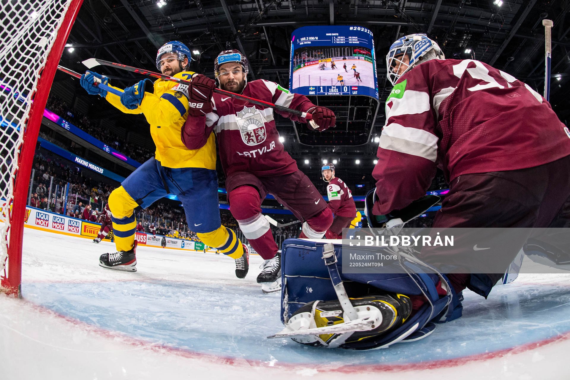 Emil Bemström of Sweden against Janis Jaks and goaltender