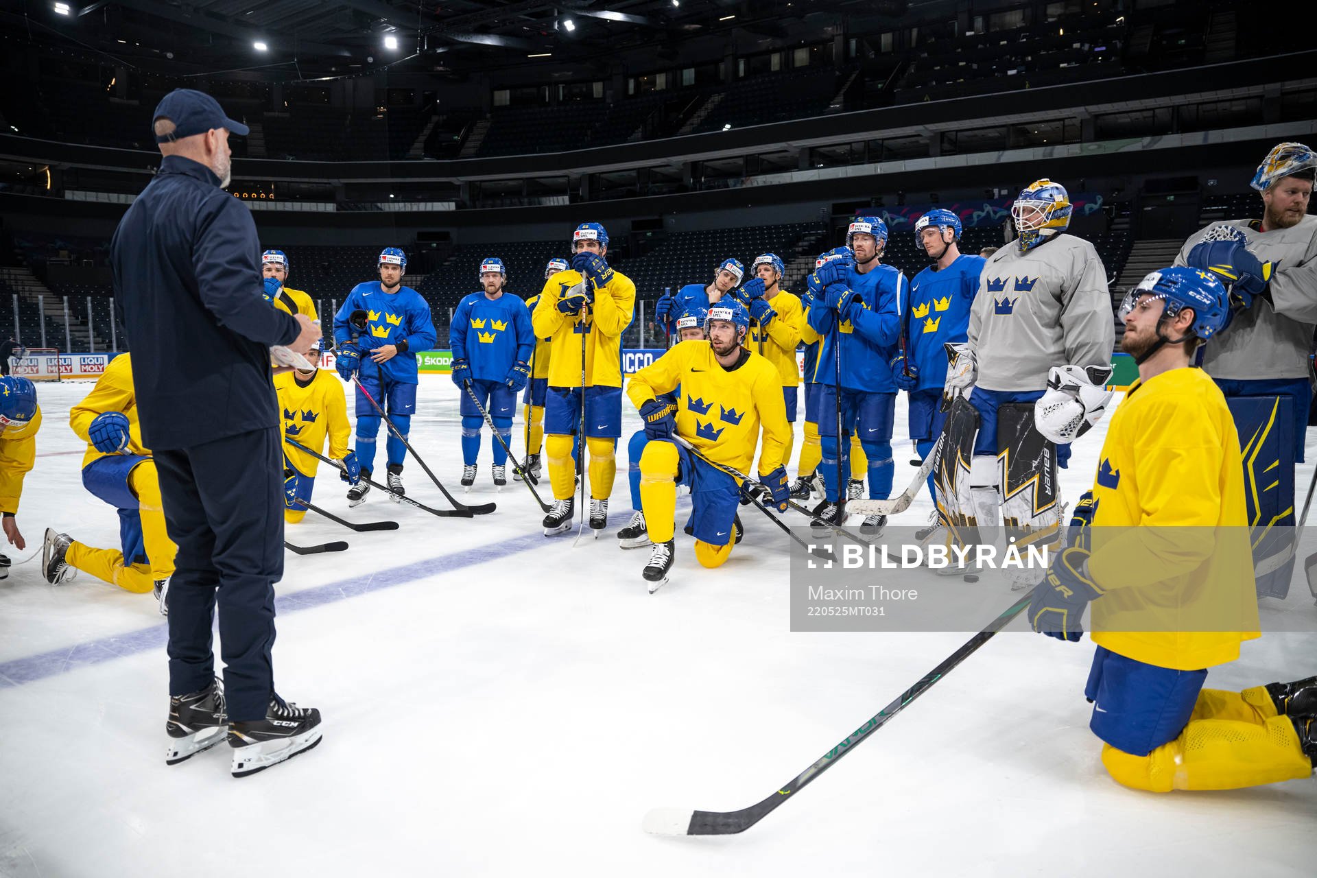 Players of Sweden gather around assistant coach Markus
