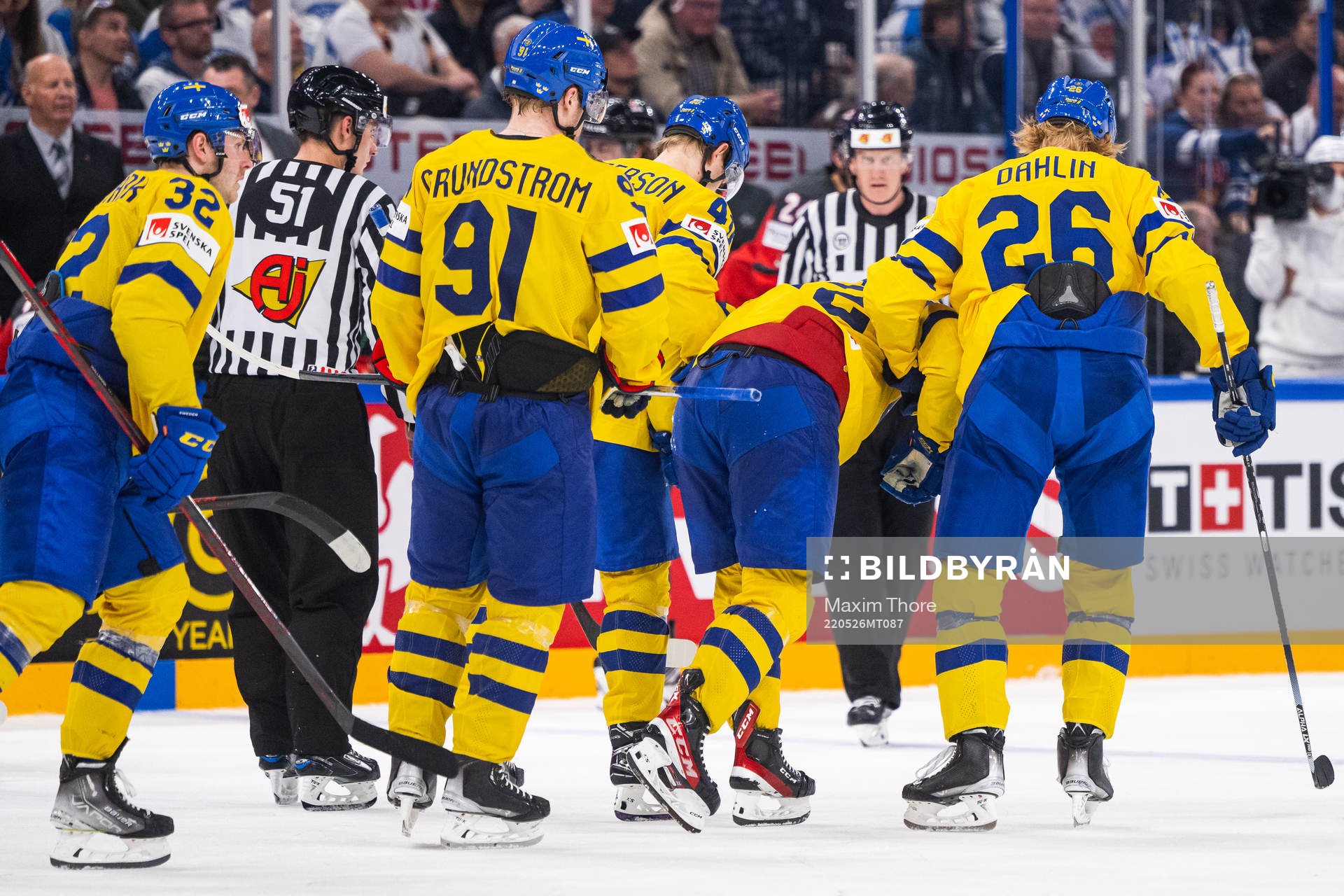Emil Bemström of Sweden receives help off the ice from