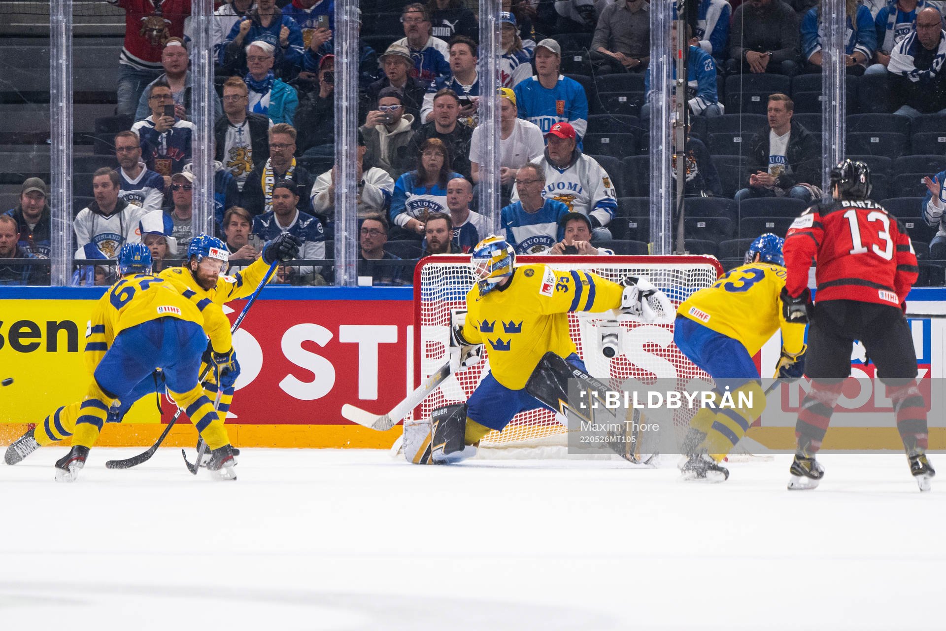 Drake Batherson of Canada scores 3-4 behind goaltender