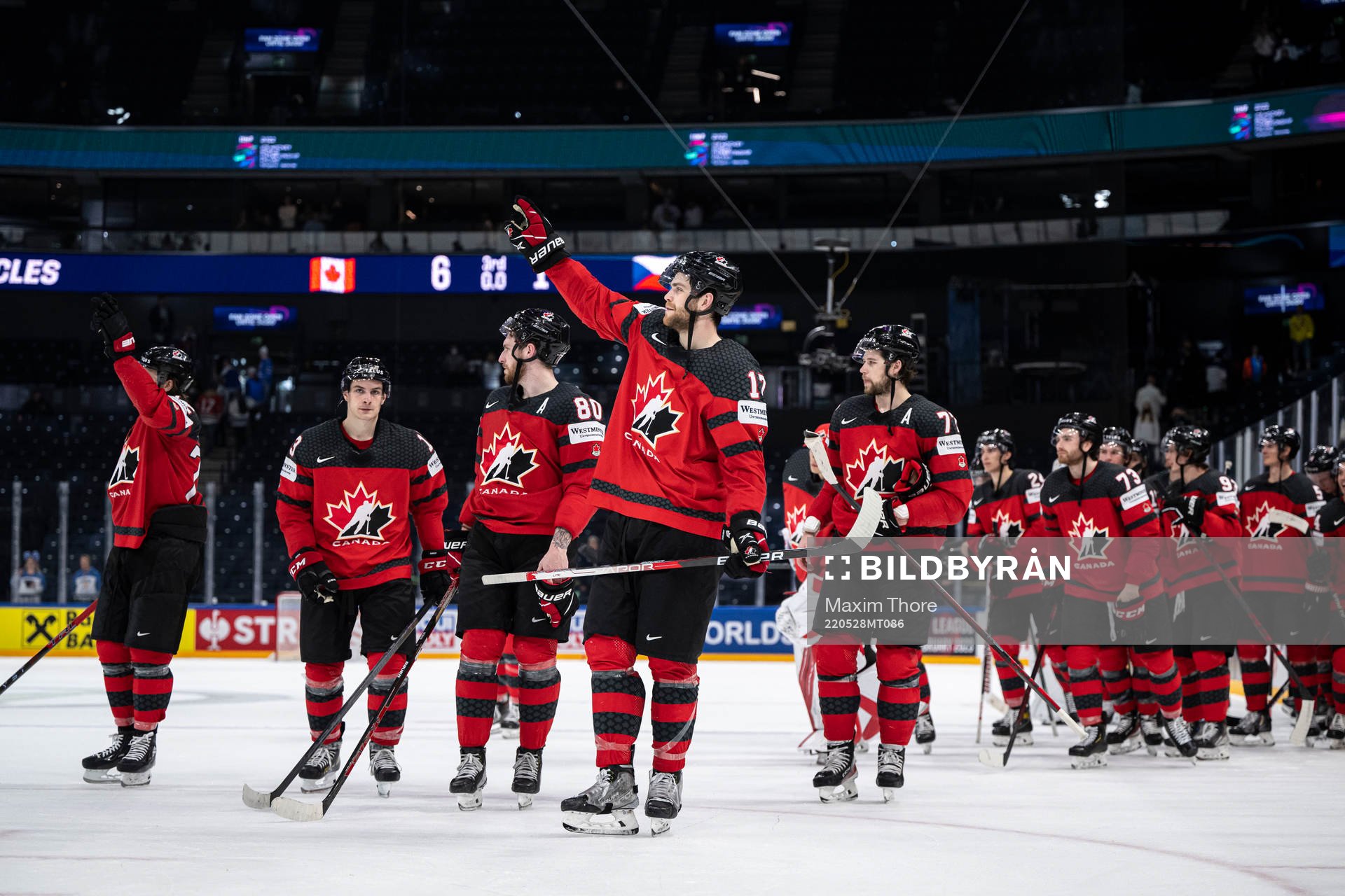 Adam Lowry of Canada celebrate with teammates