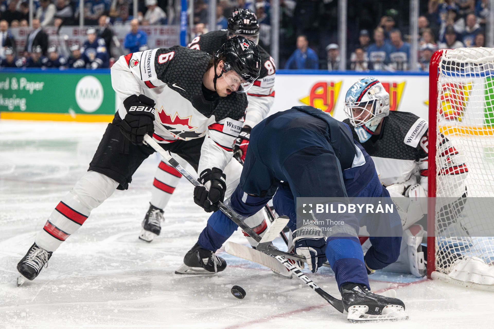 Travis Sanheim of Canada and Hannes Björninen of Finland