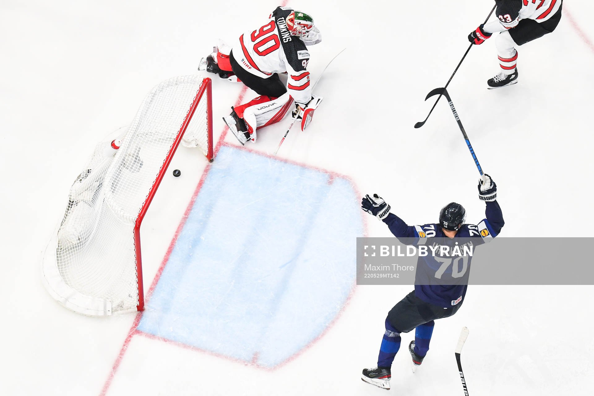 Goaltender Matt Tomkins of Canada looks dejected and Teemu
