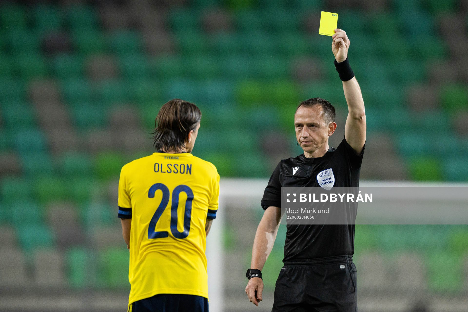 Kristoffer Olsson of Sweden receives a yellow card from