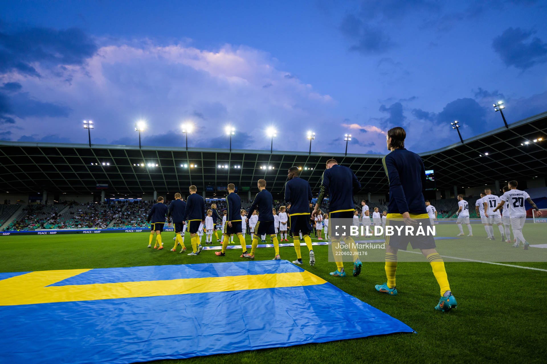Players of Sweden and of Slovenia enter the pitch for the