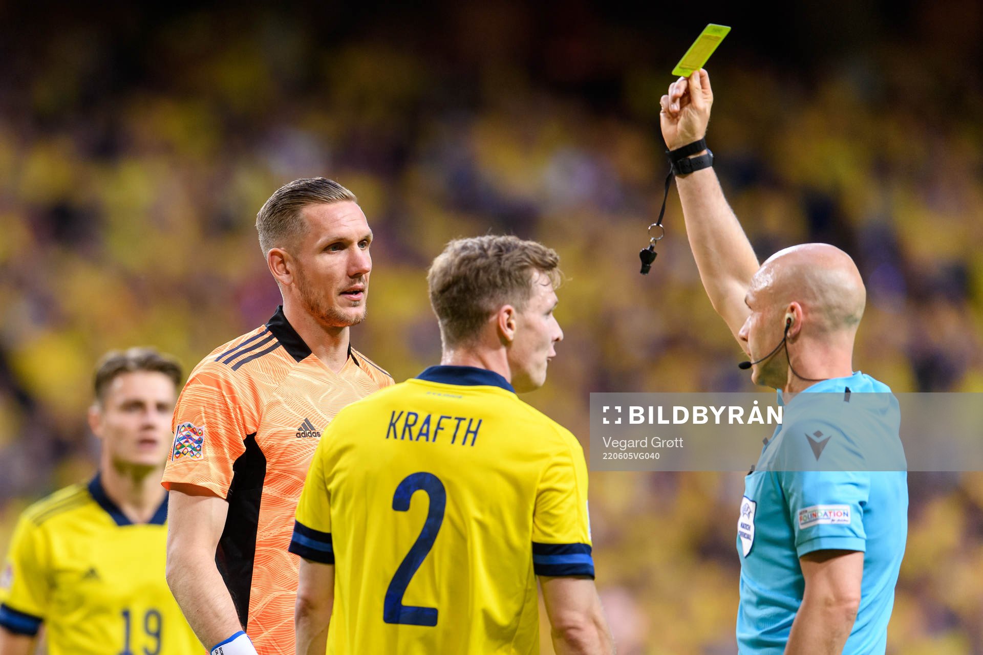 Emil Krafth of Sweden is shown a yellow card