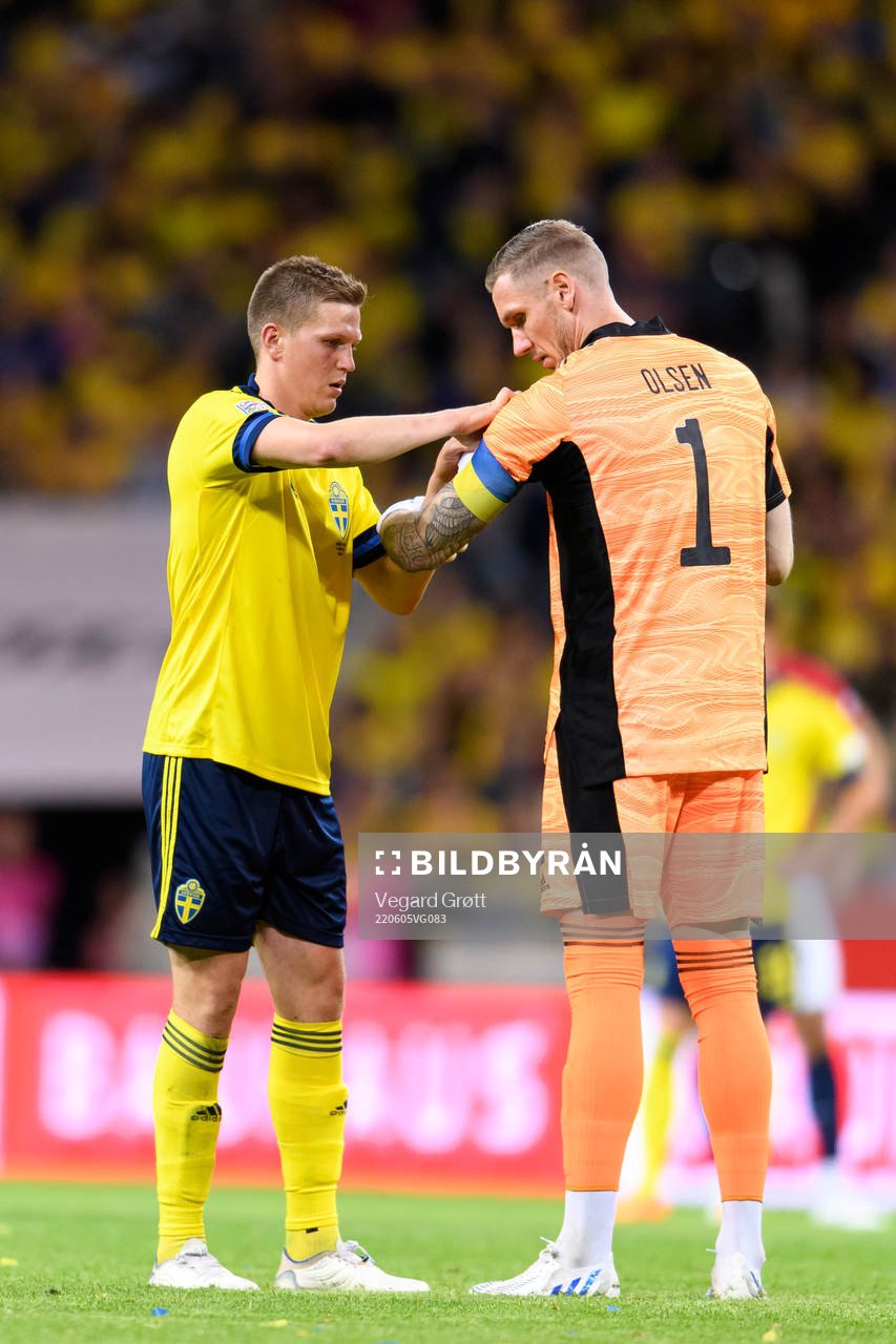 Joakim Nilsson and goalkeeper Robin Olsen of Sweden