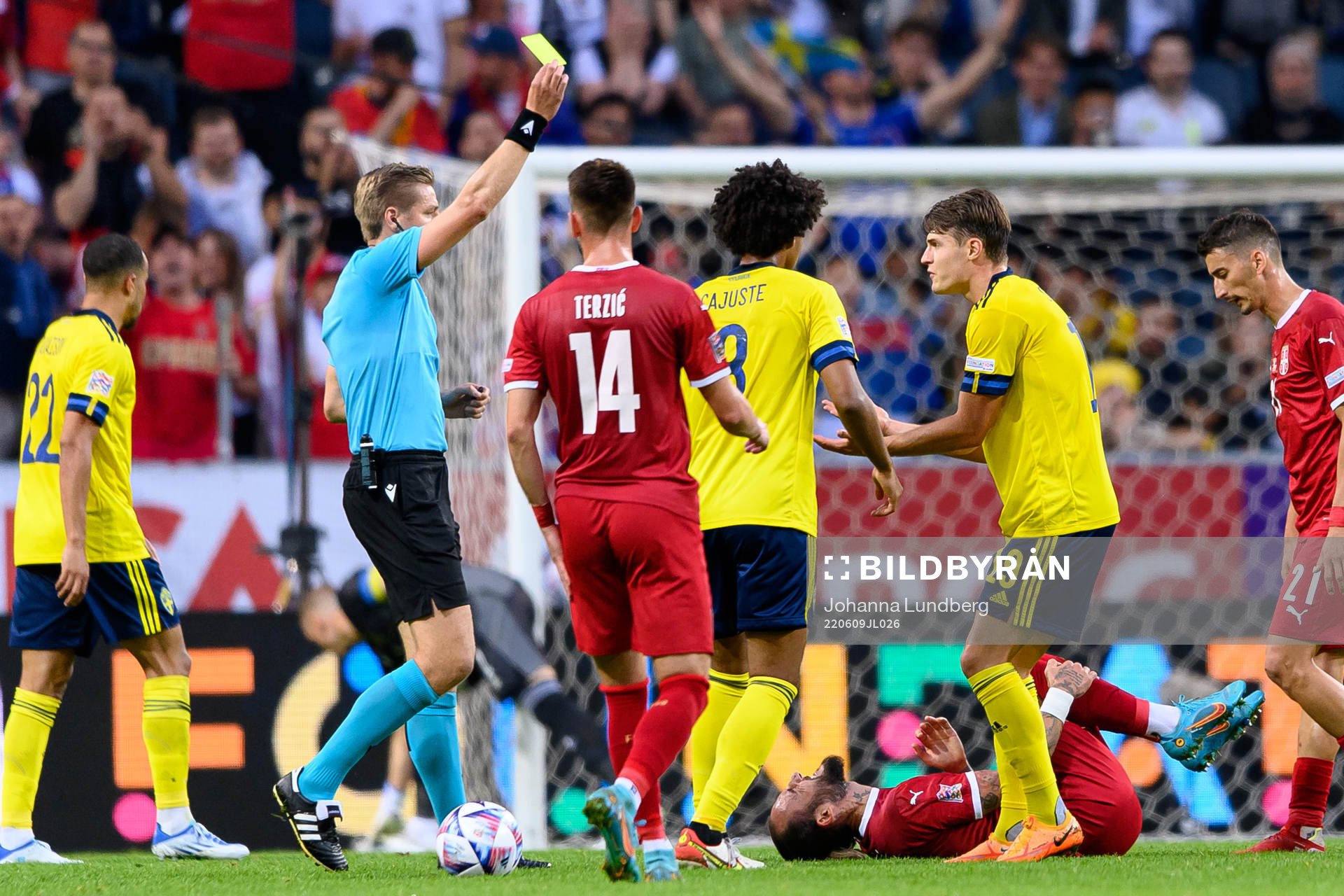 Mattias Svanberg of Sweden is shown a yellow card