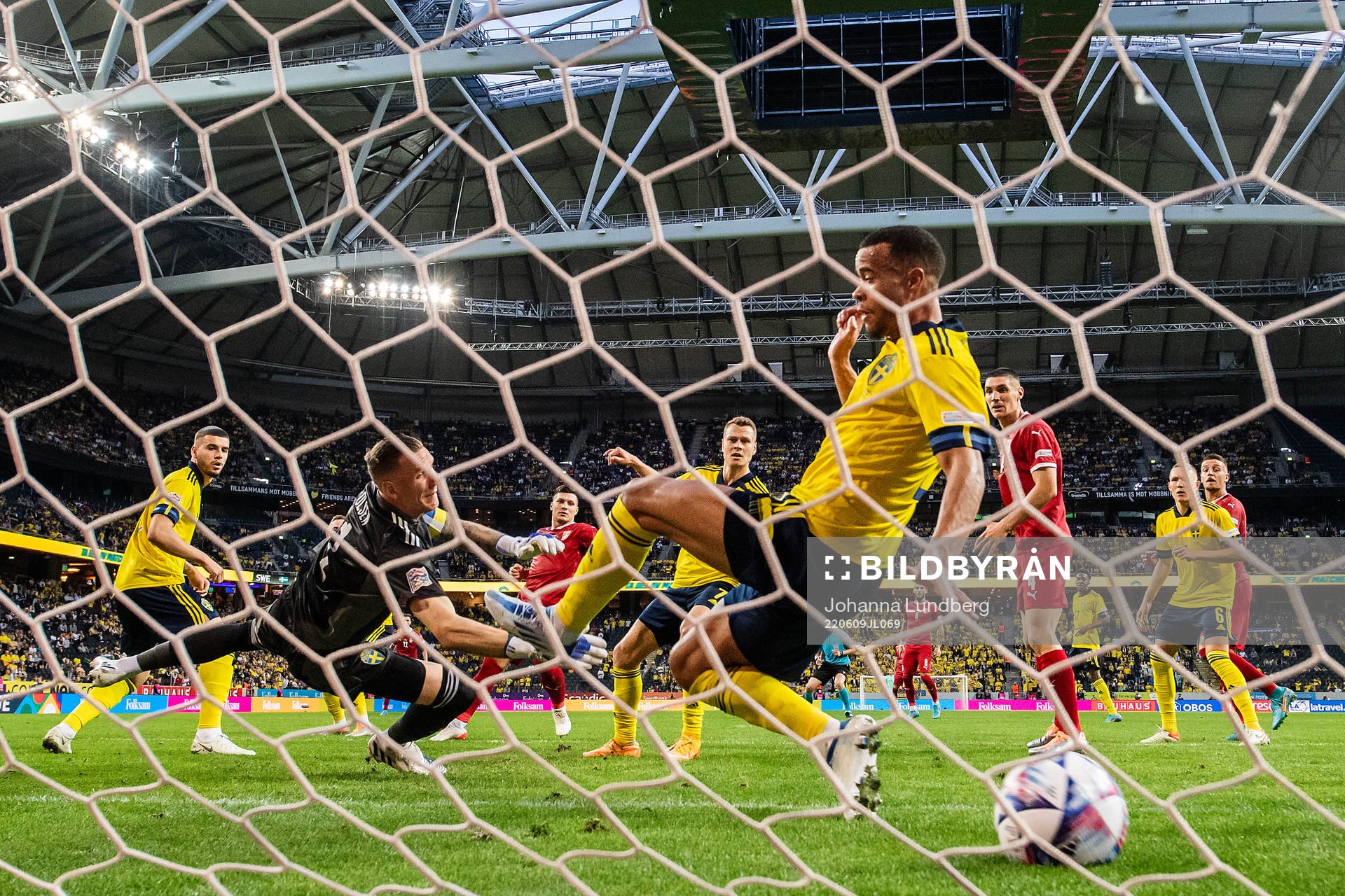 Nikola Milenkovic of Serbia scores 0-1 behind goalkeeper Robin Olsen and Robin Quaison of Sweden during the Nations League football match between Sweden and Serbia on June 9, 2022 in Stockholm. 