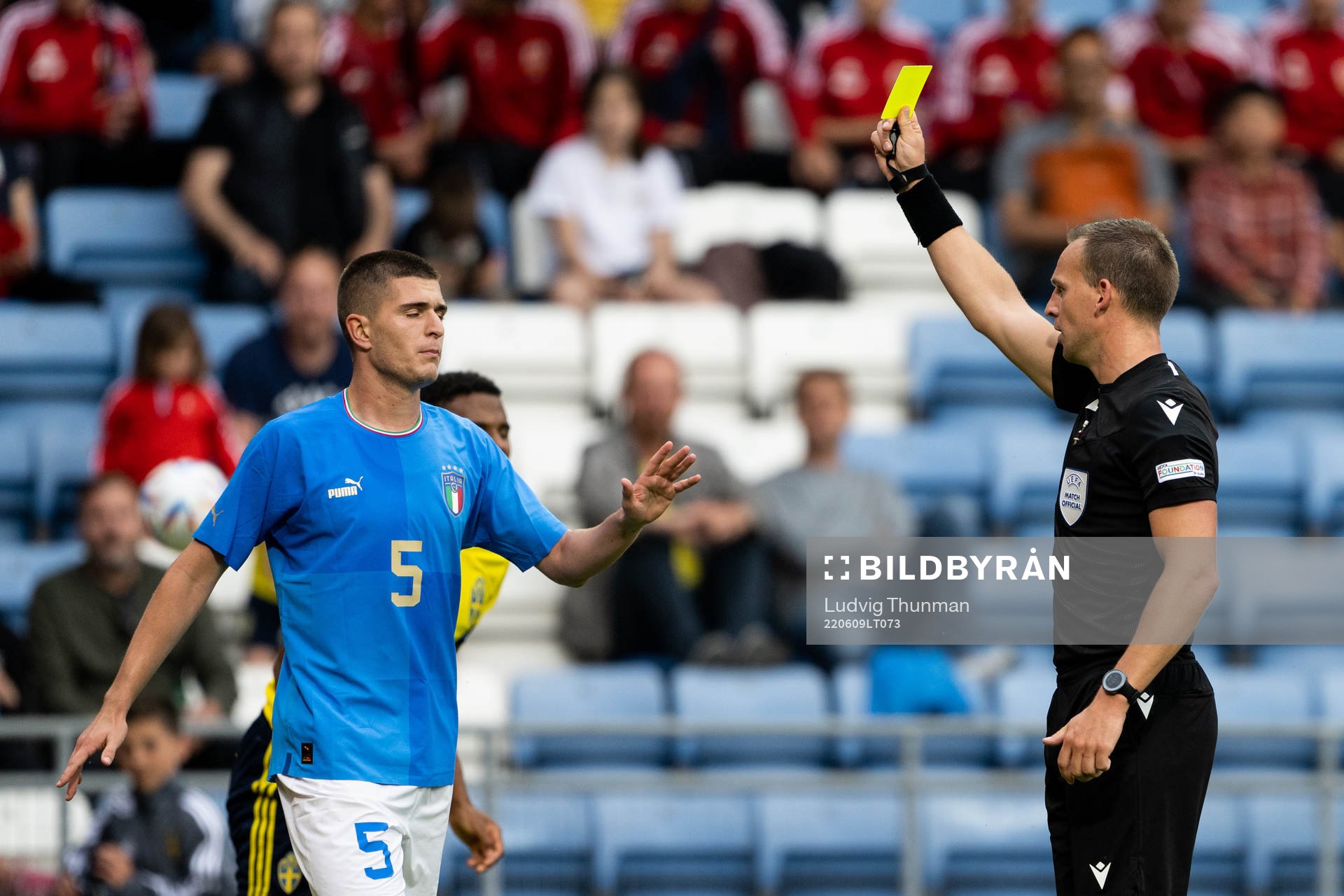 Lorenzo Pirola of Italy is shown a yellow card by referee