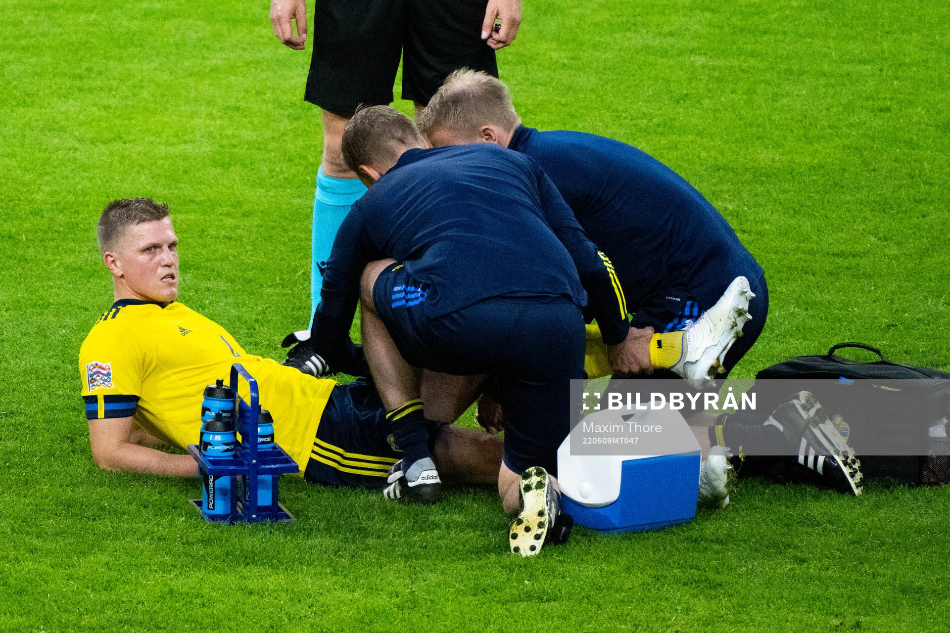 Joakim Nilsson of Sweden receives medical attentionduring