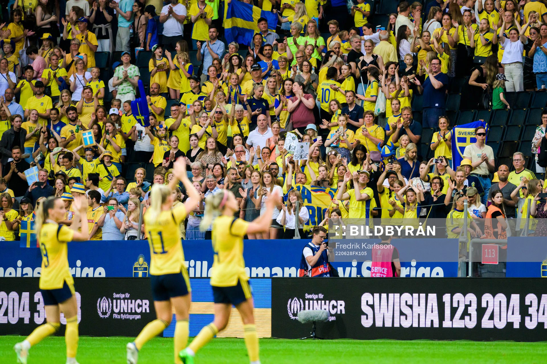 Swedish supporters celebrate with the players of Sweden