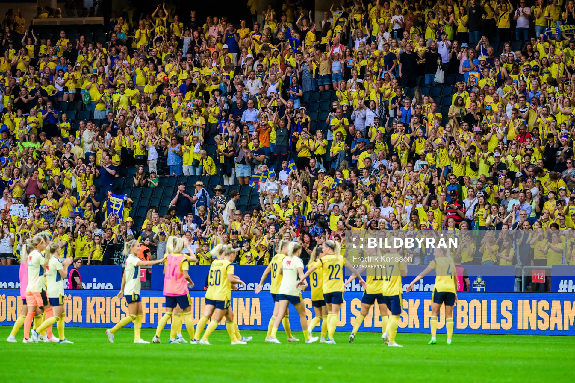 Swedish supporters celebrate with the players of Sweden