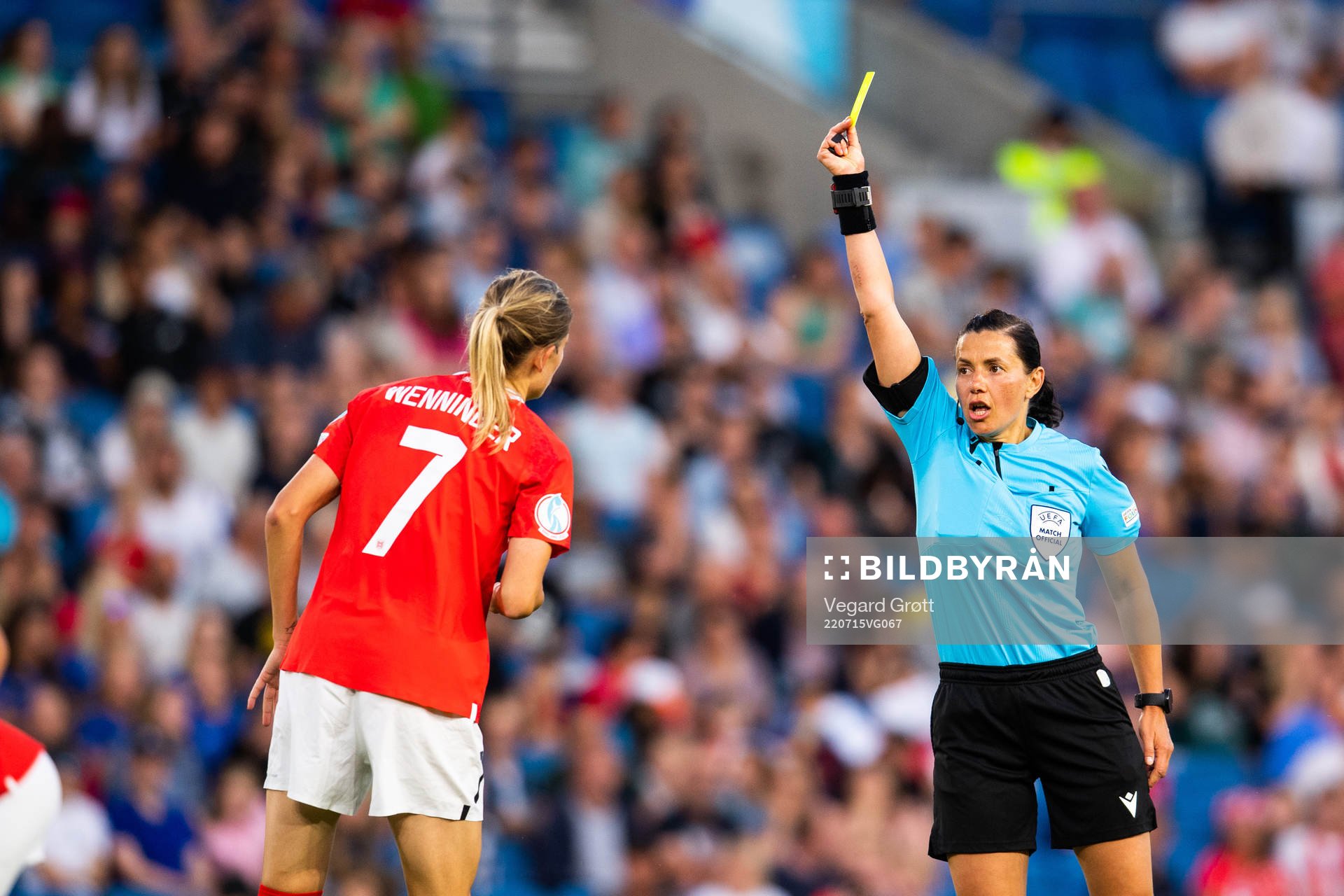 Carina Wenninger of Austria is shown a yellow card by referee Kateryna Monzul during the UEFA Women's Euro 2022 group stage match between Austria and Norway on July 15, 2022 in Brighton.