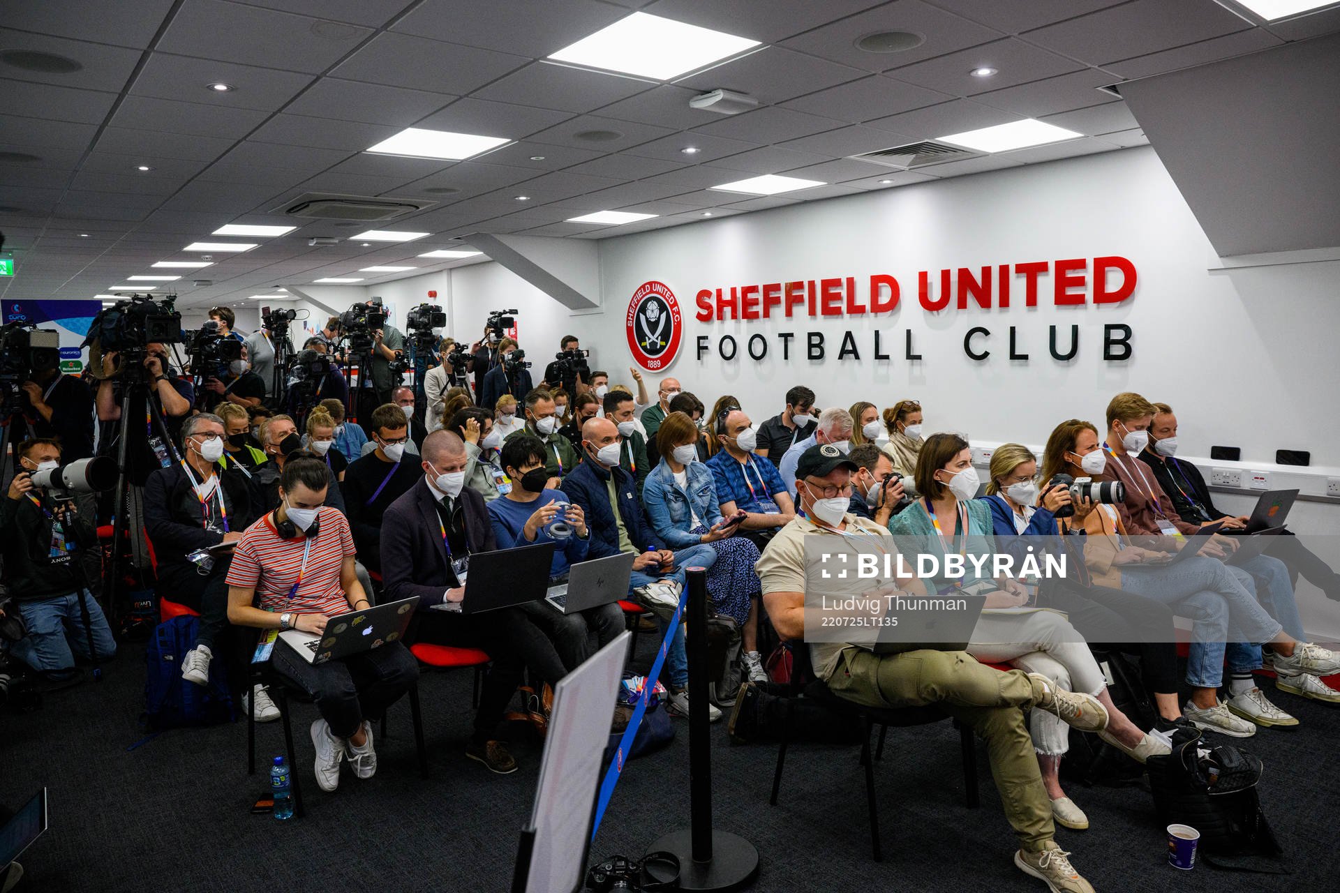 Member of the press follow a press conference with the