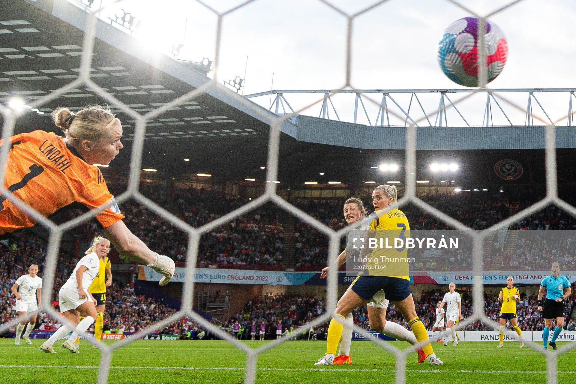 Beth Mead of England score the 1-0 goal behind goalkeeper Hedvig Lindahl and Linda Sembrant of Sweden during the UEFA Women's Euro 2022 semifinal match between England and Sweden on July 26, 2022 in Sheffield. 