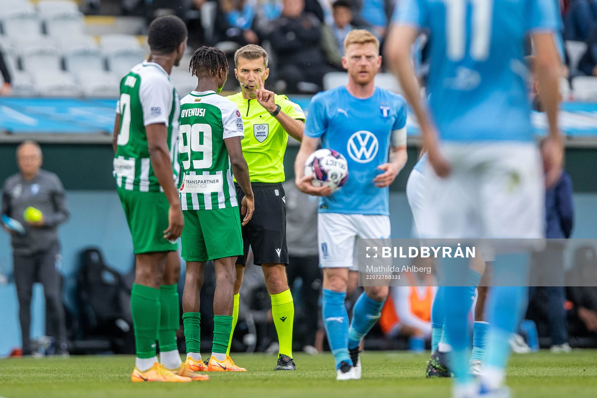 Referee Kristo Tohver and Kehinde Mathias Oyewusi of