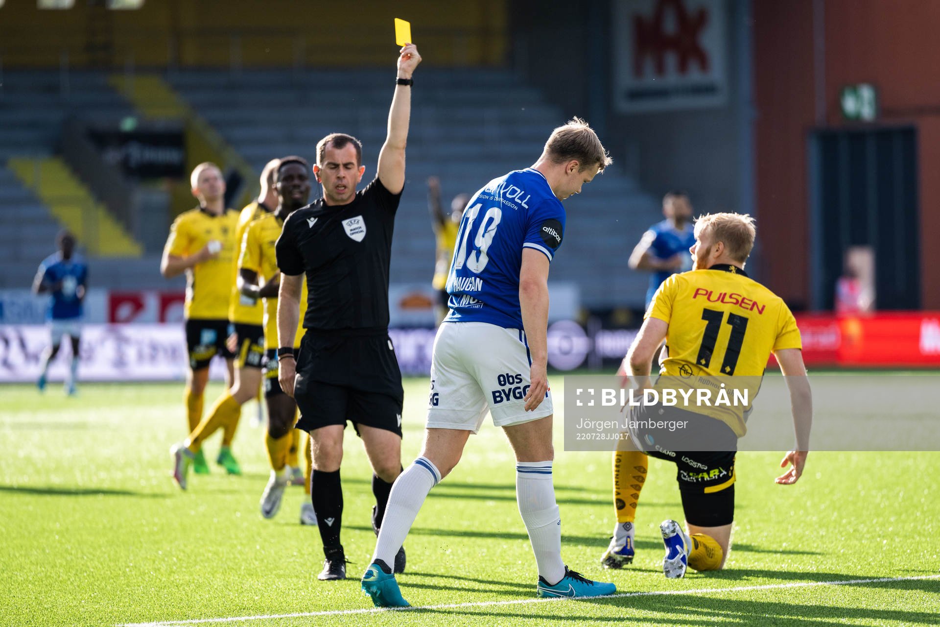 Referee Peter Bankes gives Eirik Haugan of Molde a yellow