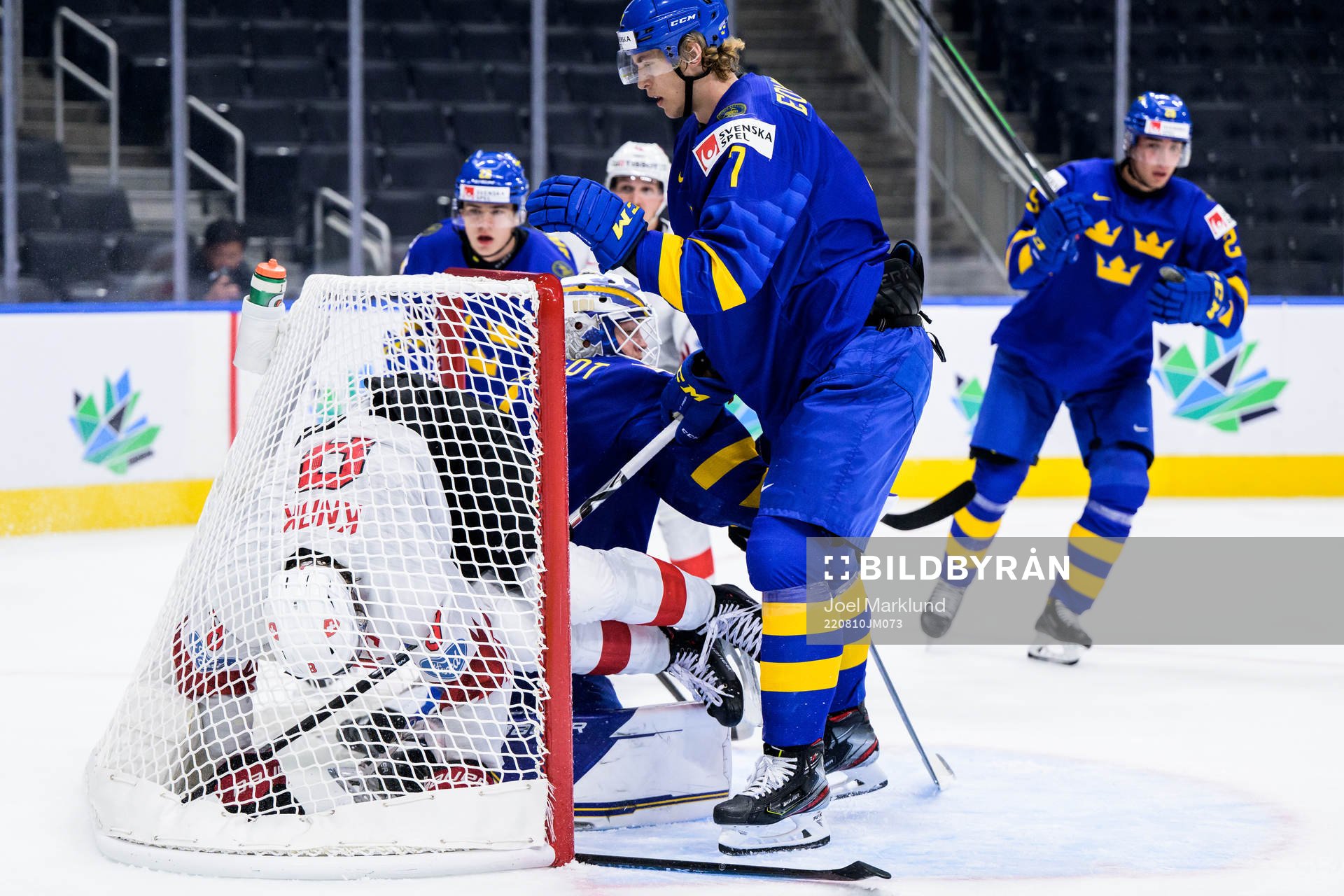 Simon Knak of Switzerland against goaltender Jesper