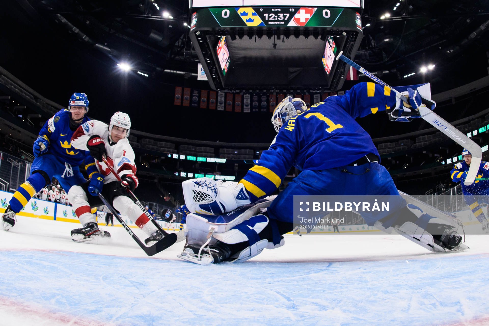 Ludvig Jansson and goaltender Jesper Wallstedt of Sweden