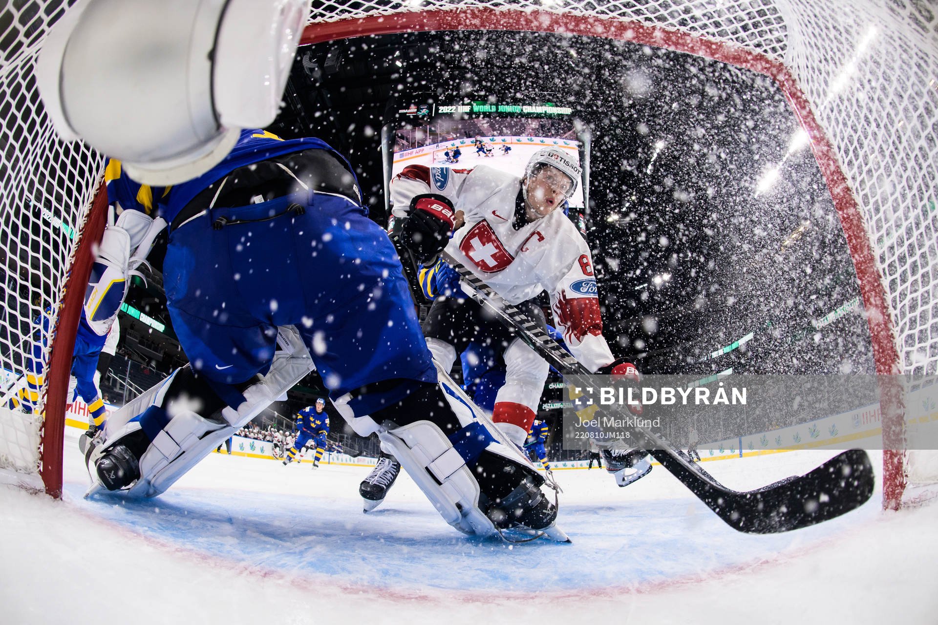 Simon Knak of Switzerland crashes into the goal behind