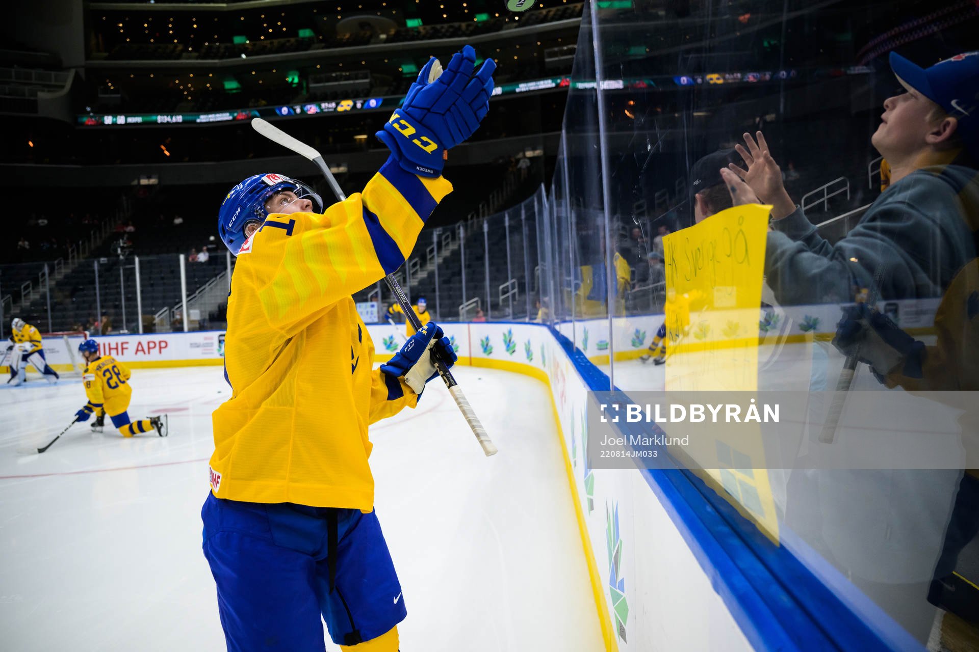 Victor Stjernborg of Sweden tosses a puck to a fan at
