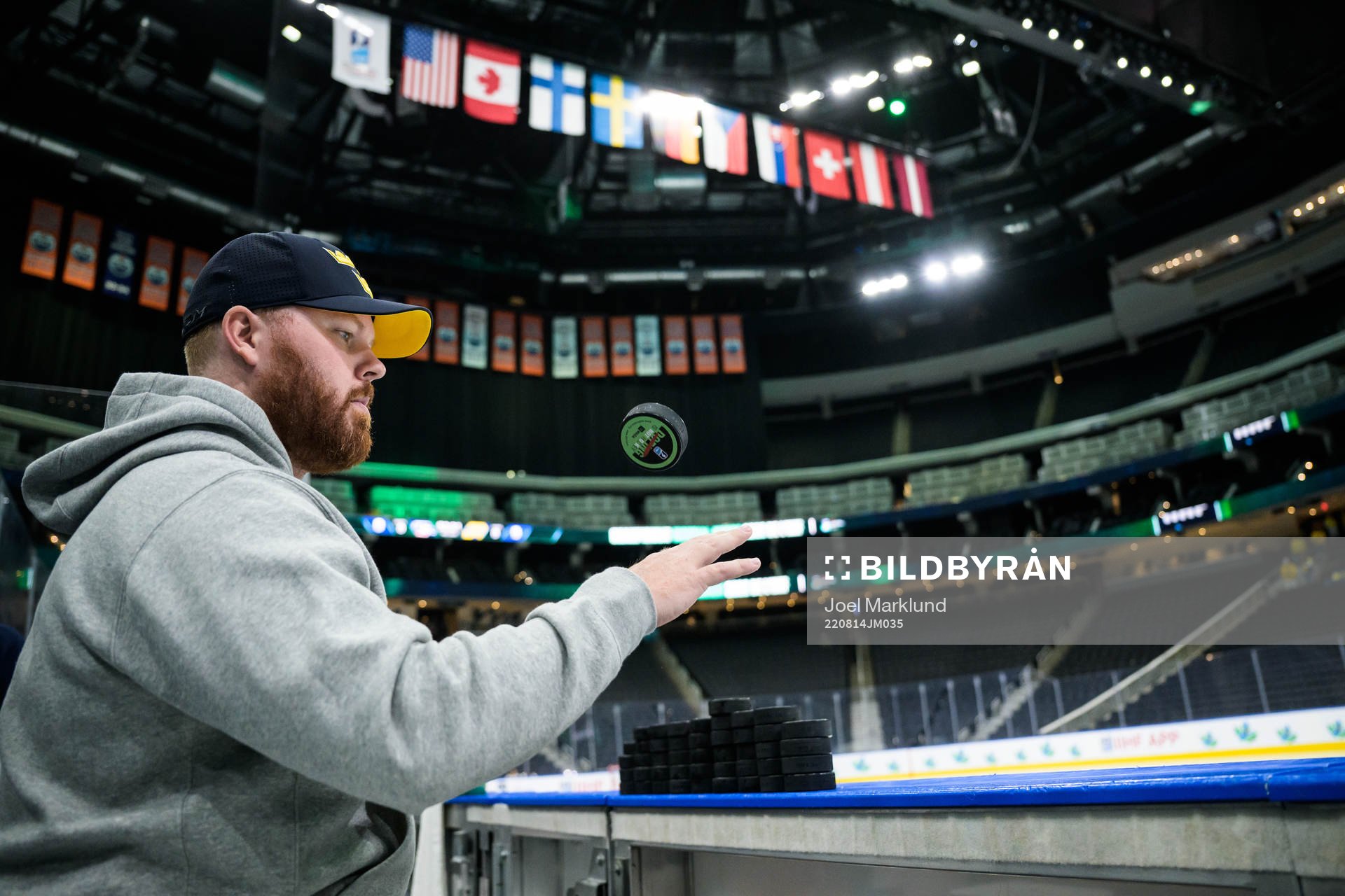 Equipment manager Andy Fagerström of Sweden flips a puck