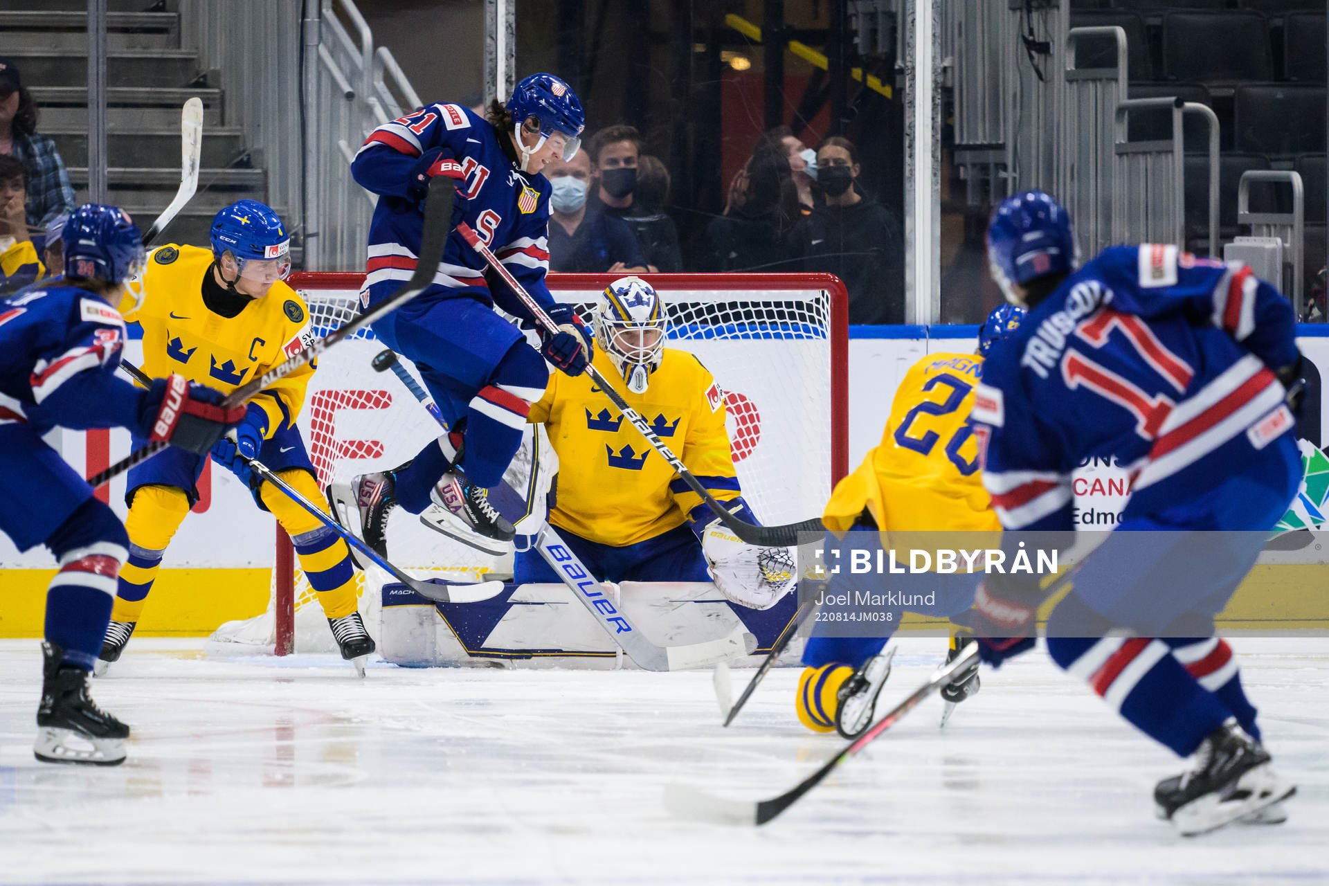 Brett Berard of USA jumps in front of goaltender Jesper