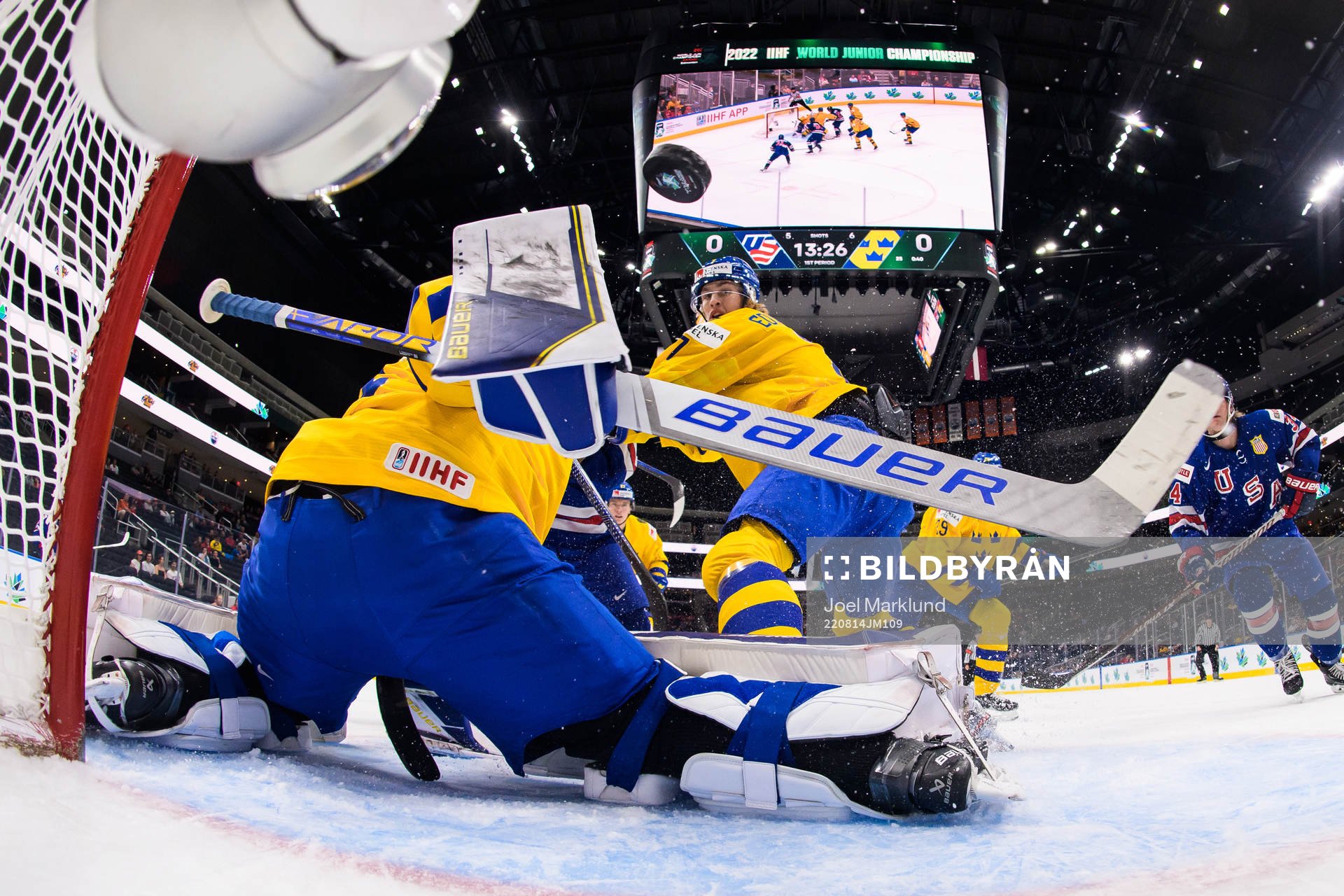 Brett Berard of USA scores 1-0 behind goaltender Jesper