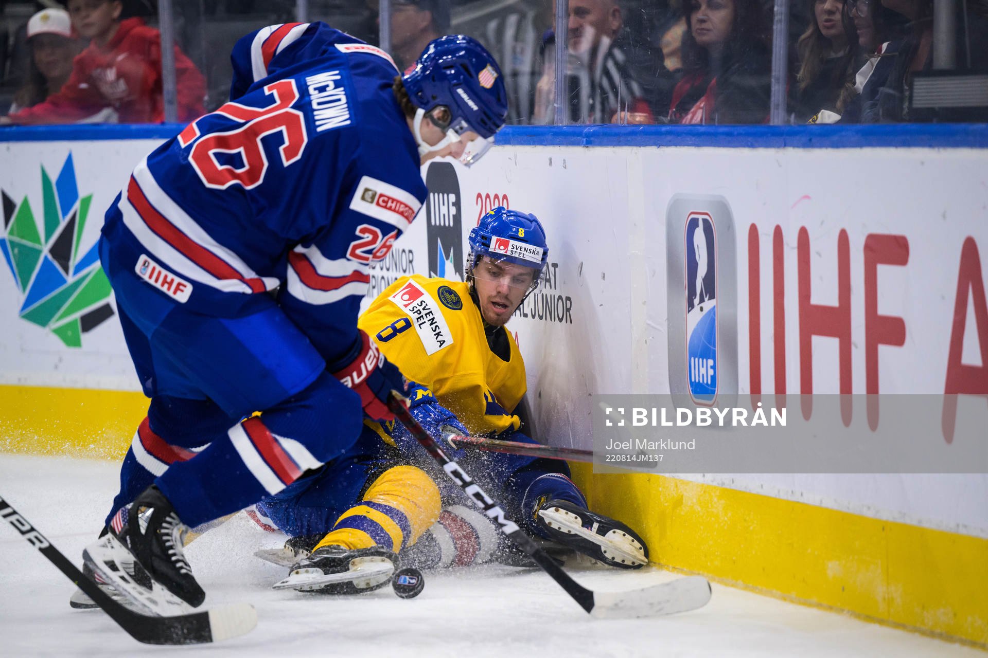 Leo Lööf of Sweden holds the puck against Hunter McKown