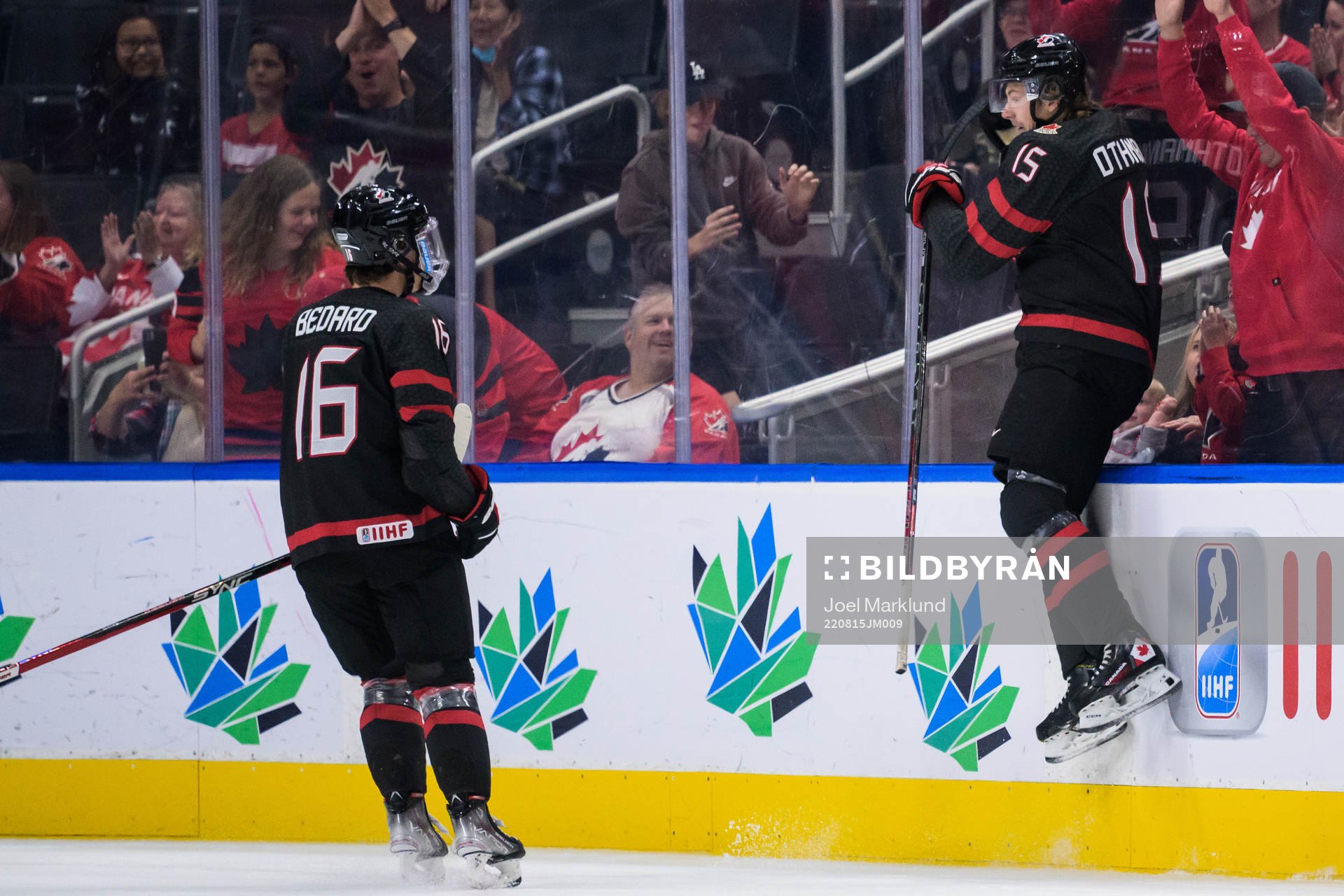 Connor Bedard and Brennan Othmann of Canada celebrate the