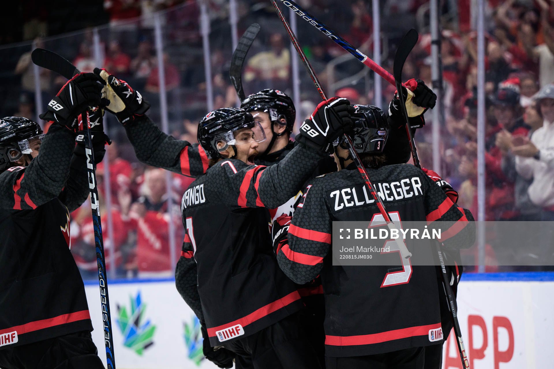 Ridly Greig of Canada celebrates with teammates