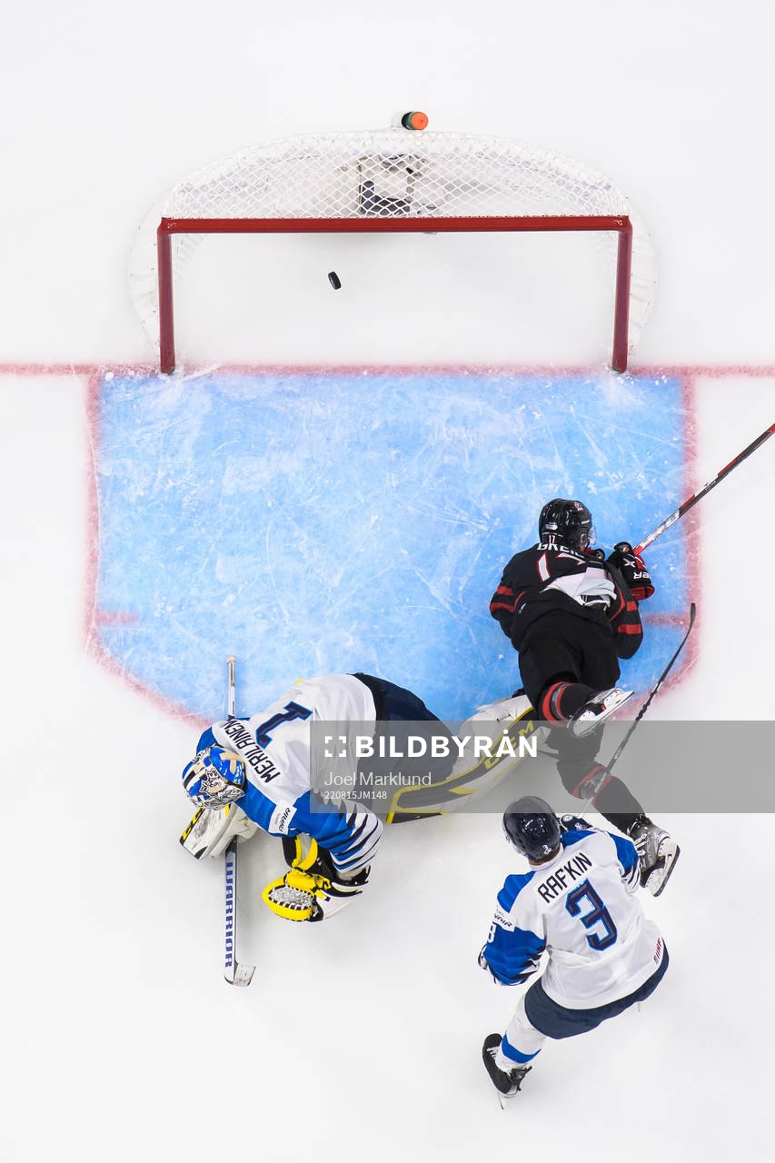 Ridly Greig of Canada scores 4-1 behind goaltender Leevi