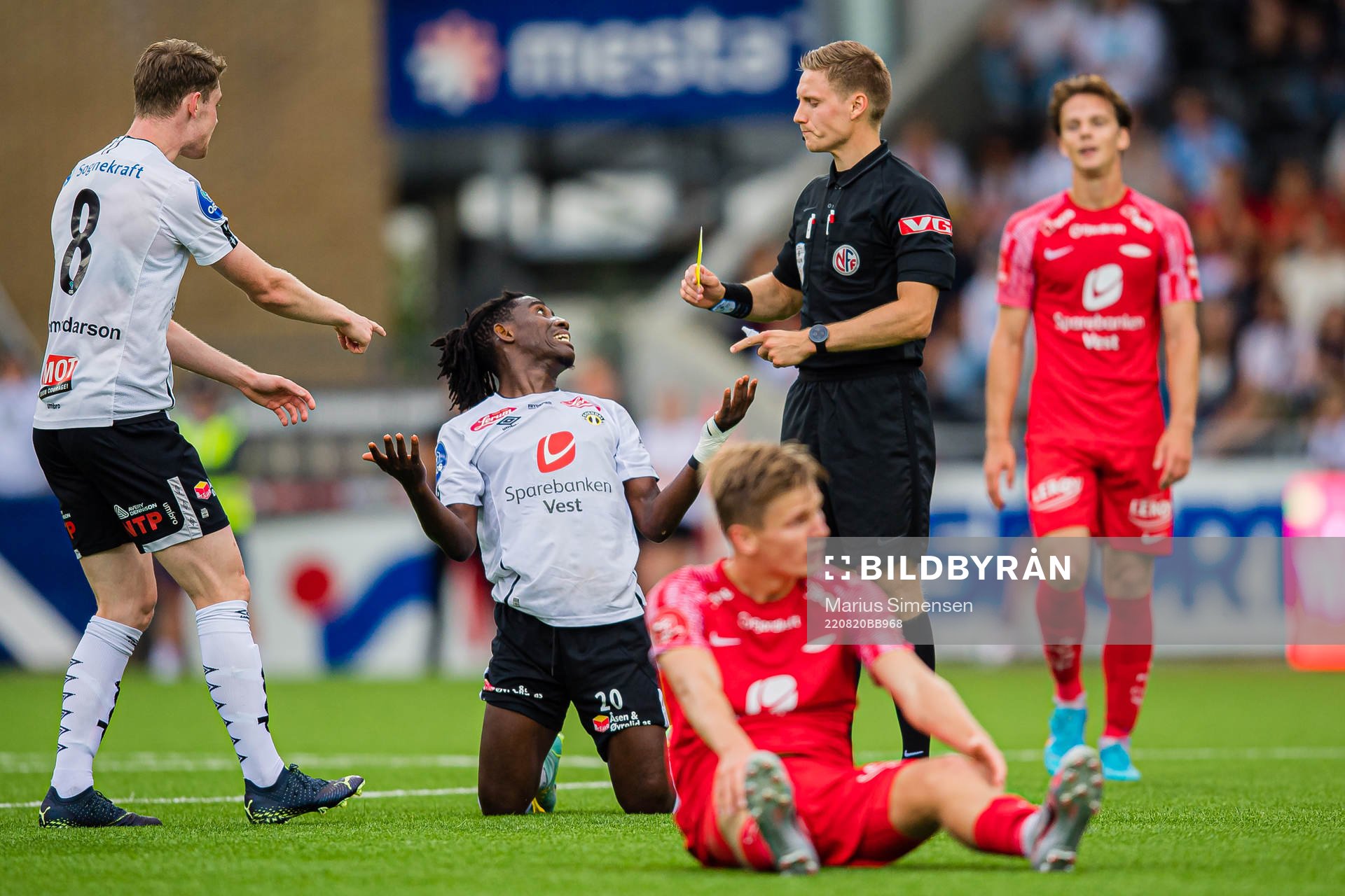 Isaac Twum of Sogndal after receiving his second yellow card by Mathias Støfringshaug, referee, during the OBOS-ligaen match between Sogndal and Brann on August 20, 2022 in Sogndal.