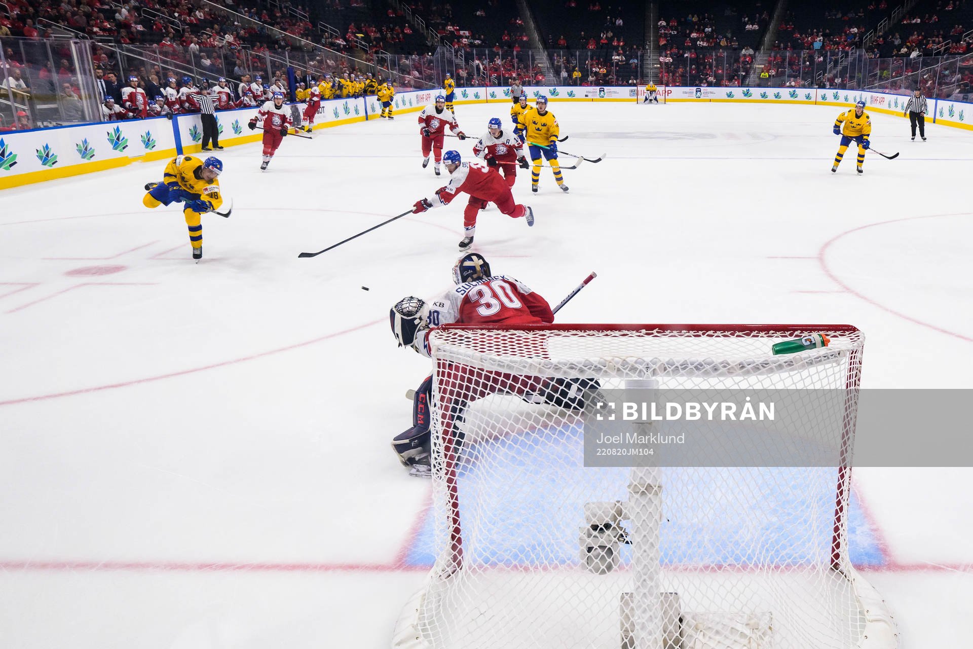 Linus Sjödin of Sweden scores 3-1 behind goaltender Tomas