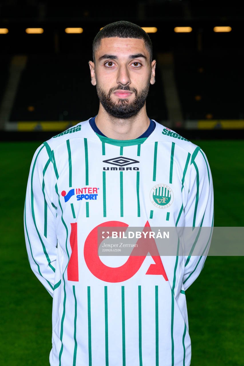 Aiham Ousou poses for a portrait with the jersey of his