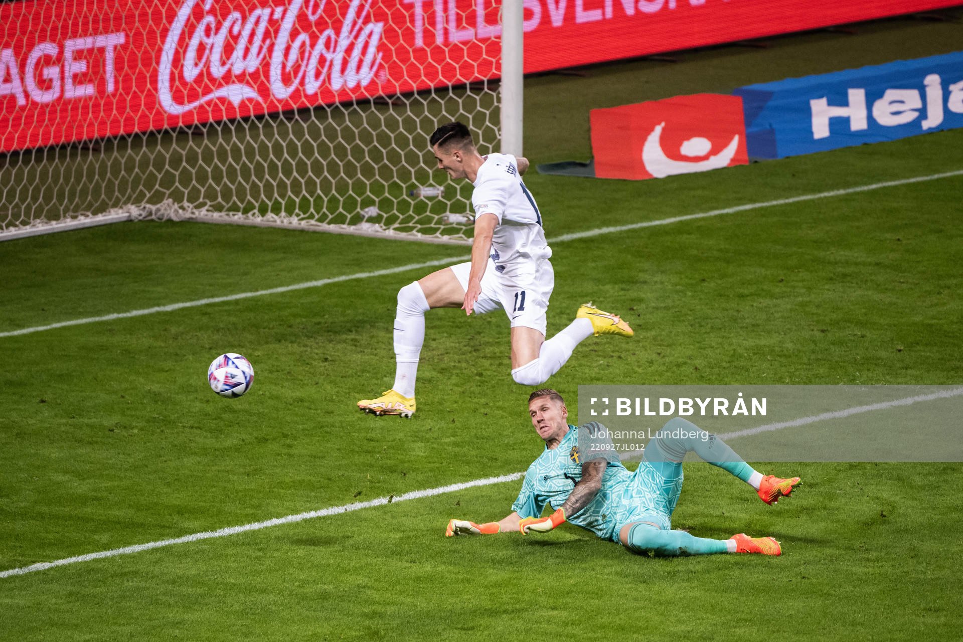 Benjamin Sesko of Slovenia and goalkeeper Robin Olsen of
