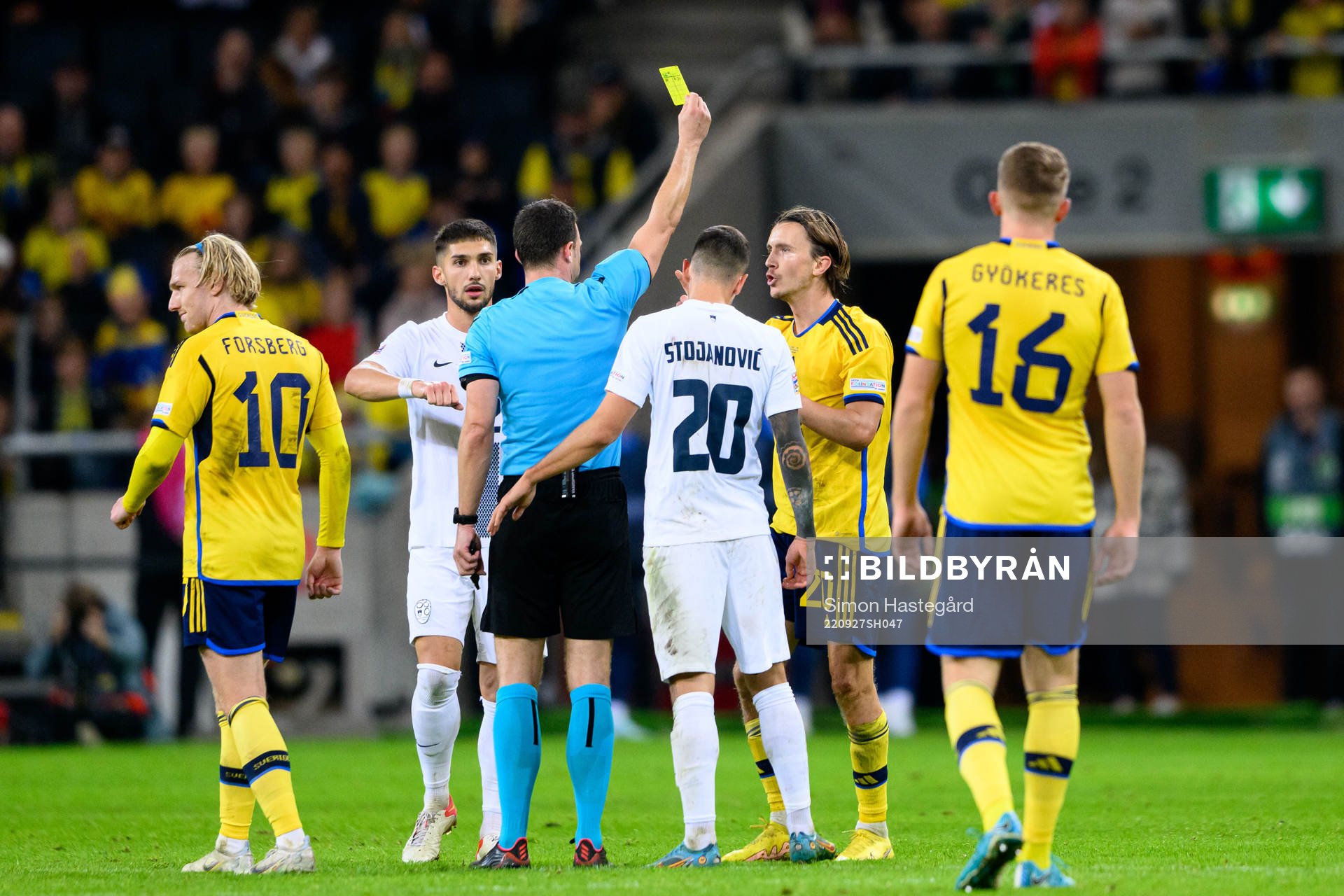 Kristoffer Olsson of Sweden receives a yellow card