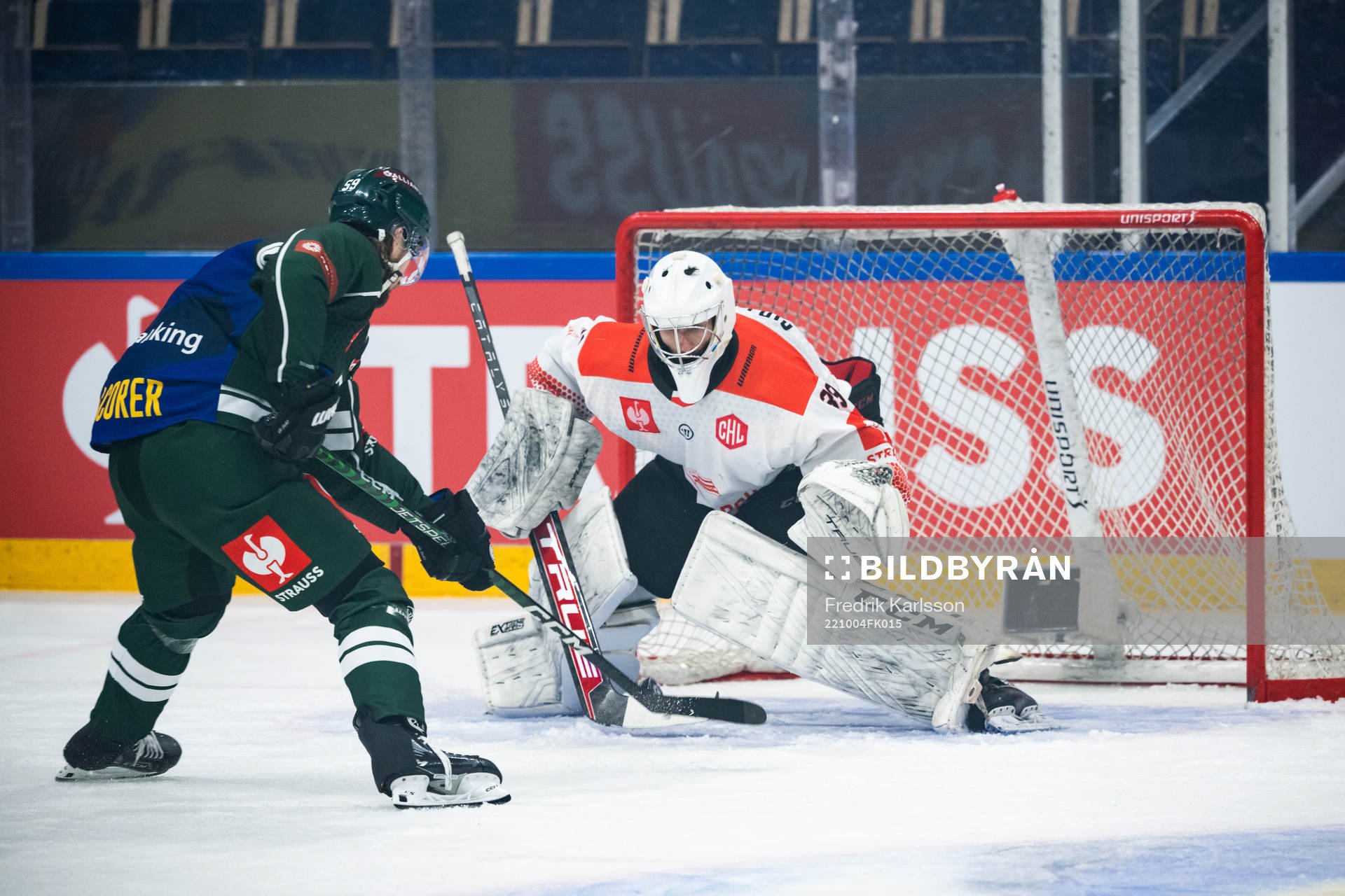 Linus Johansson of Färjestad and goaltender Rok Stojanovic