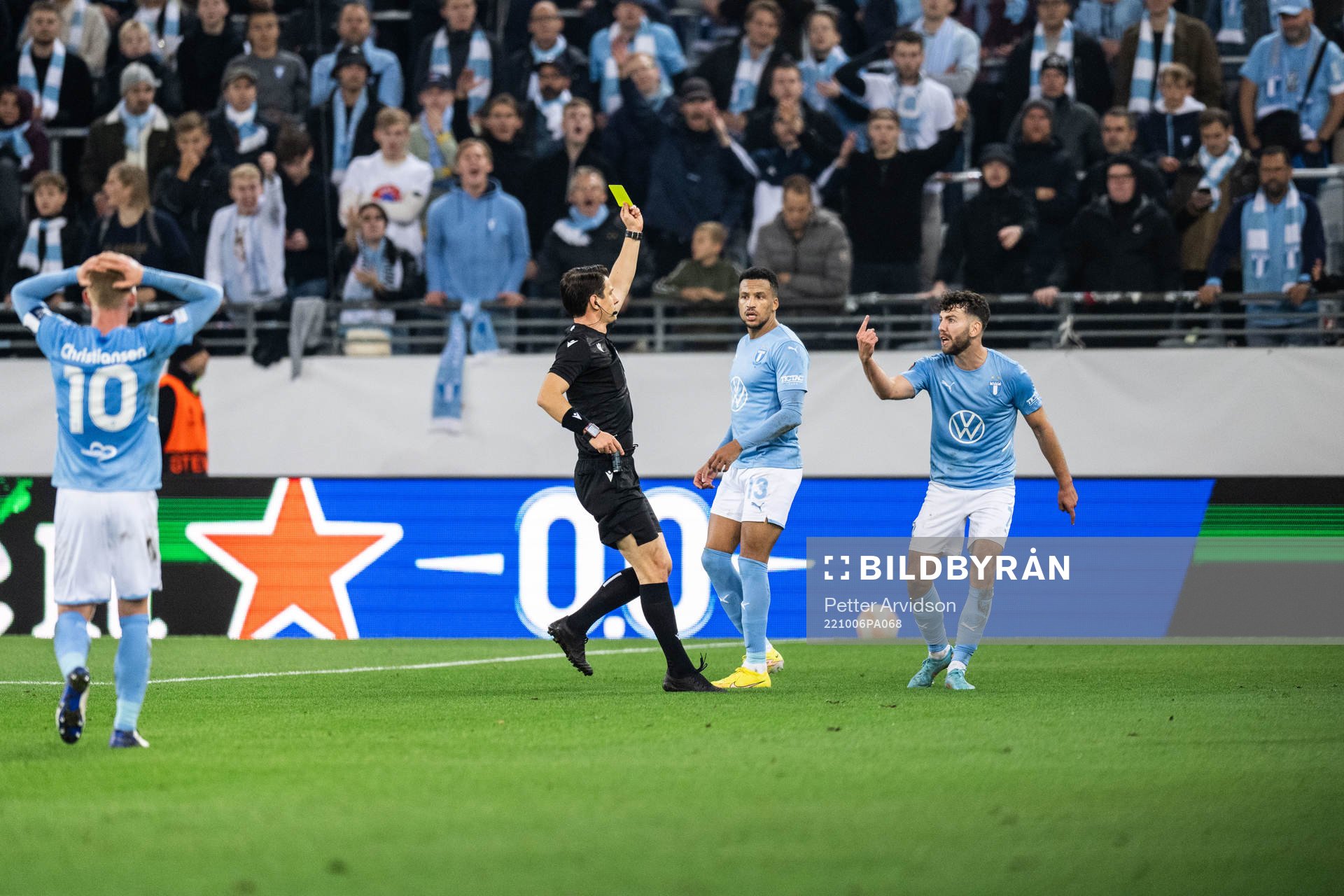 Erdal Rakip of Malmö FF receives a yellow card from