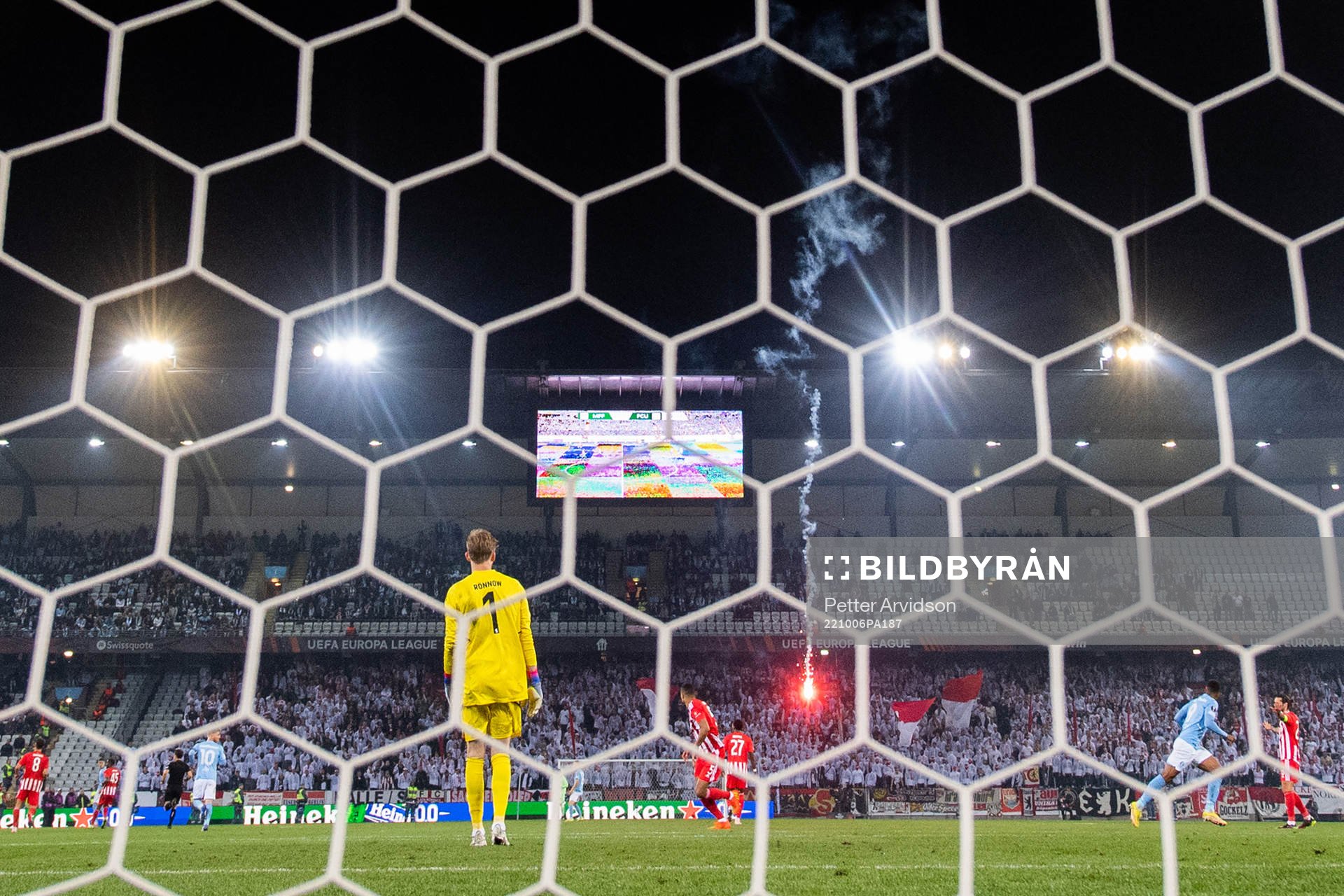 A flare is thrown onto the pitch