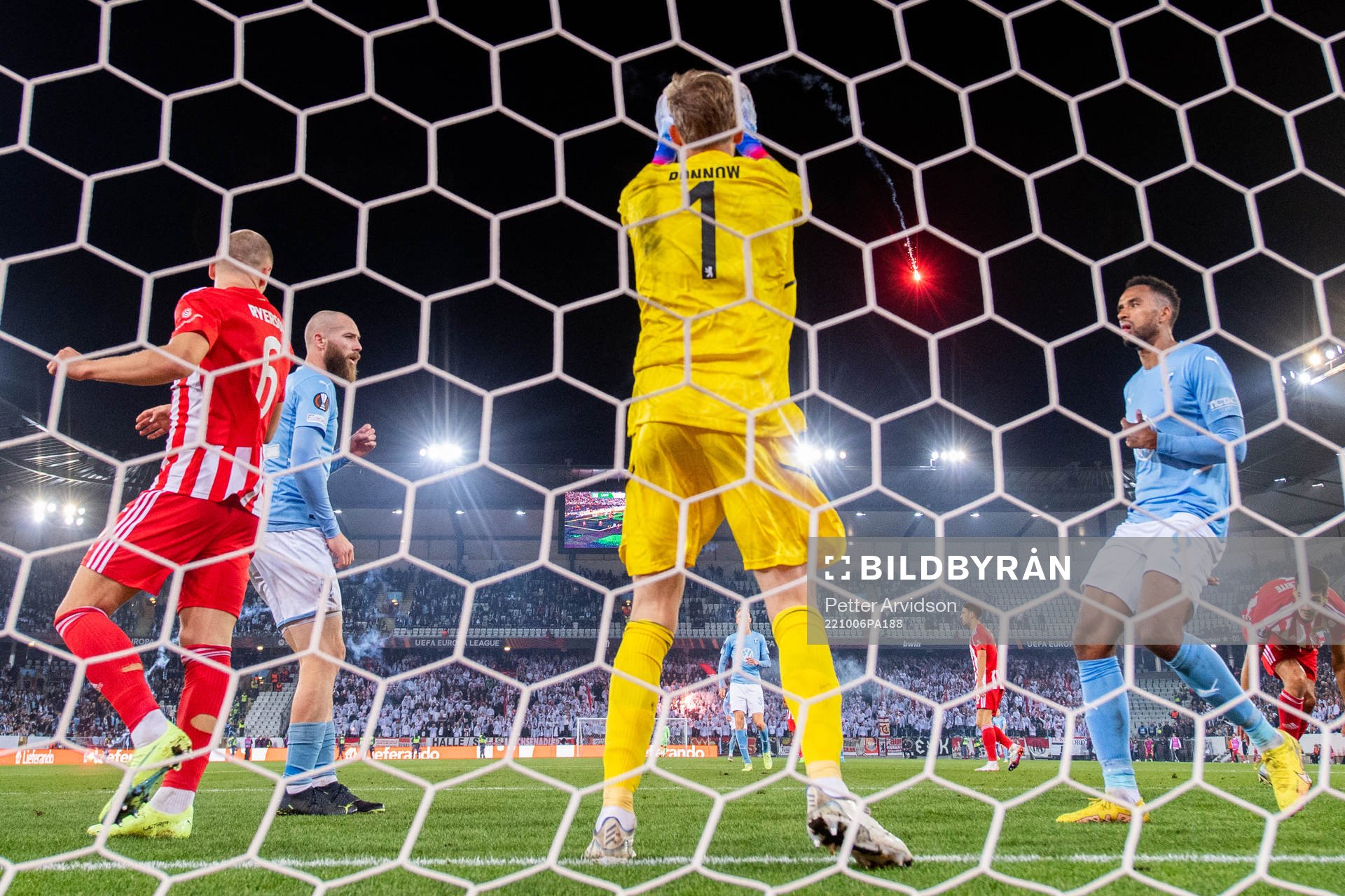A flare is thrown onto the pitch as goalkeeper Frederik