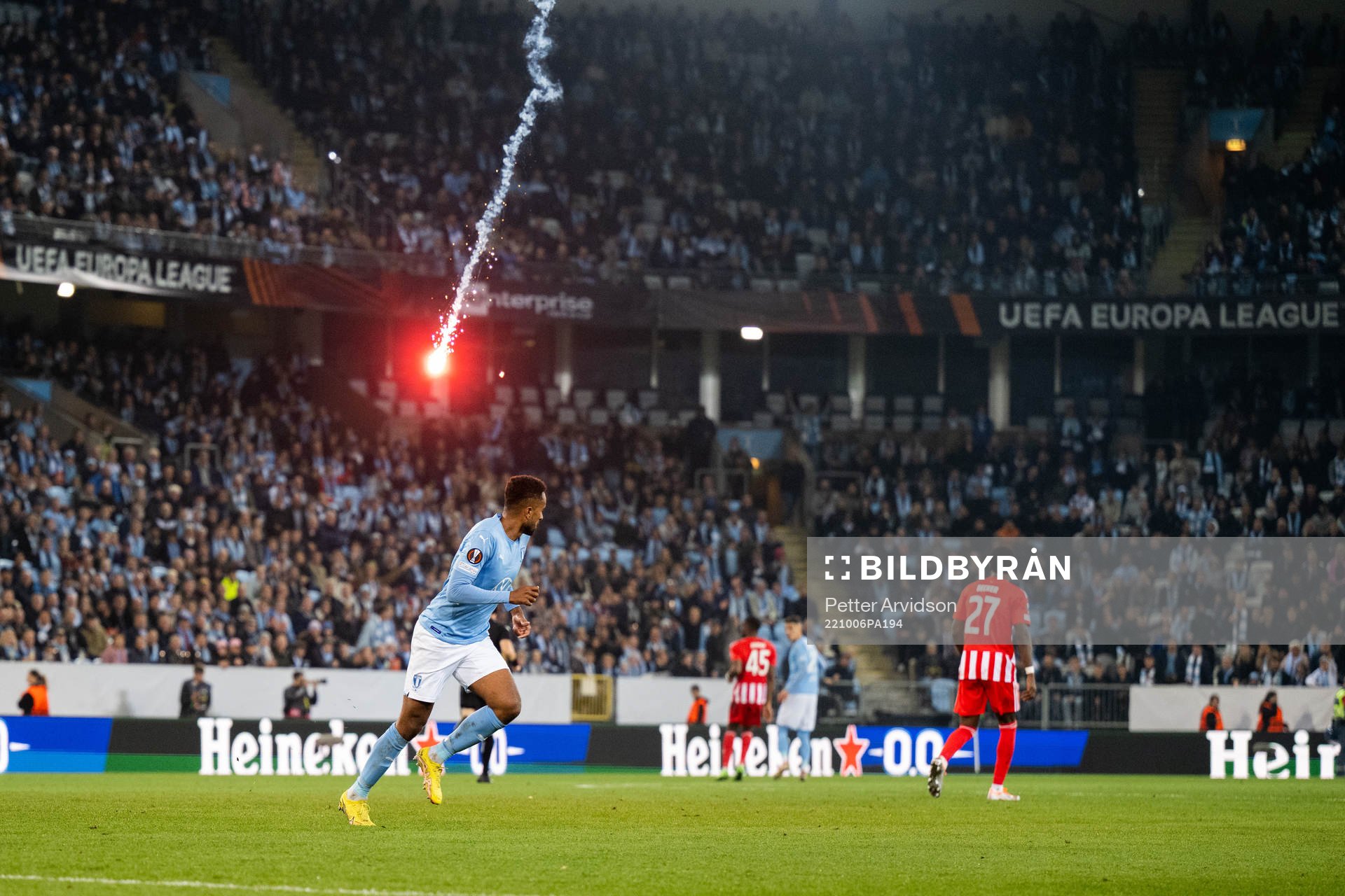 A flare is thrown onto the pitch